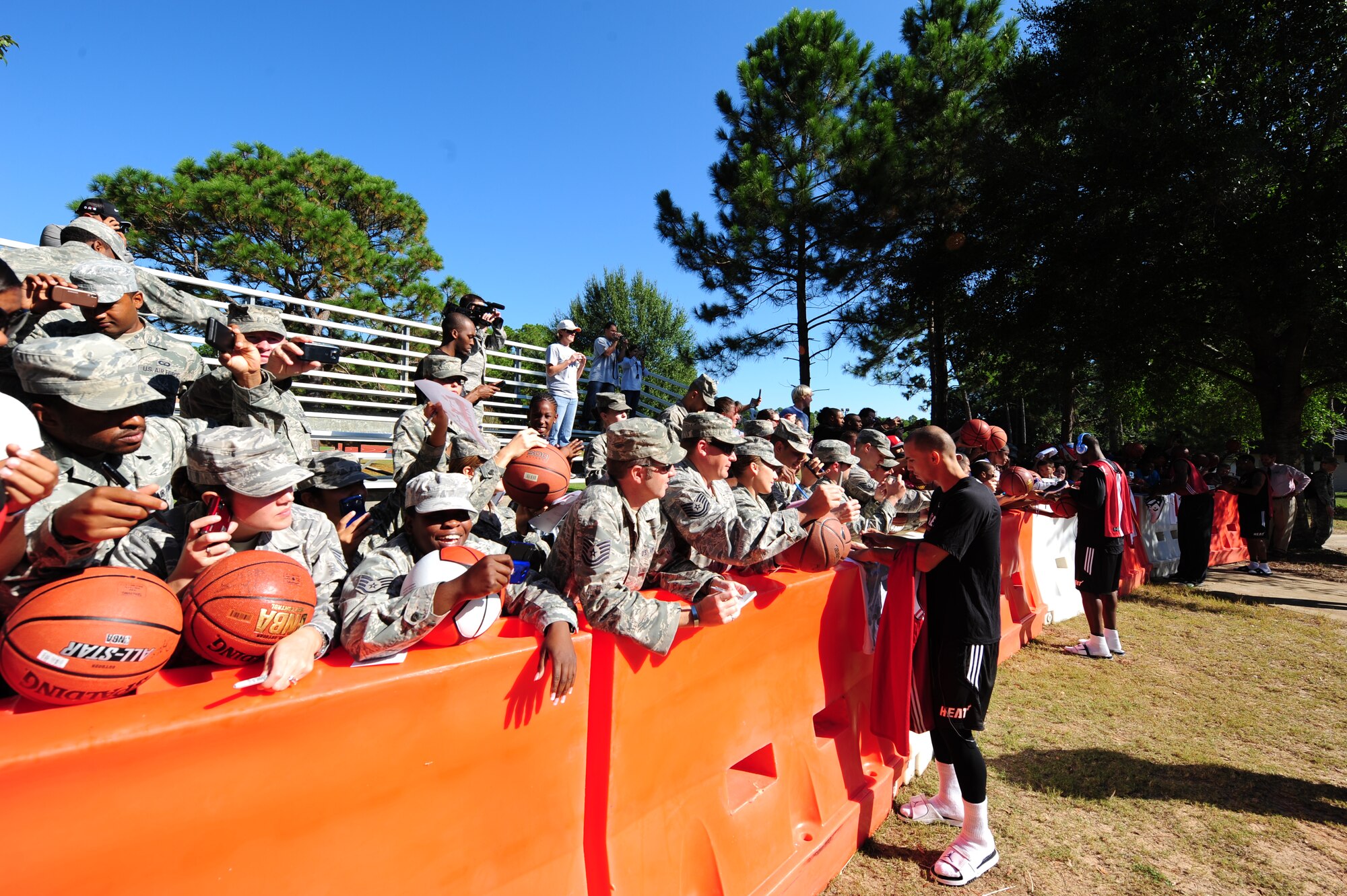 Members of the Miami HEAT team sign autographs for fans before heading into practice during the Miami HEAT 2010 Training Camp at the Aderholt Fitness Center, Hurlburt Field, Fla., Sept. 29, 2010. This is the first time in 23 years the HEAT has taken their training camp on the road.  Hurlburt Field will play host to the team’s contingent of 44 from Sep. 28, through Oct. 3, 2010.  Players and staff have allotted time throughout the week to visit with Air Commandos at different work centers across base. (DoD Photo by Staff Sgt. Stephanie Jacobs/RELEASED)
