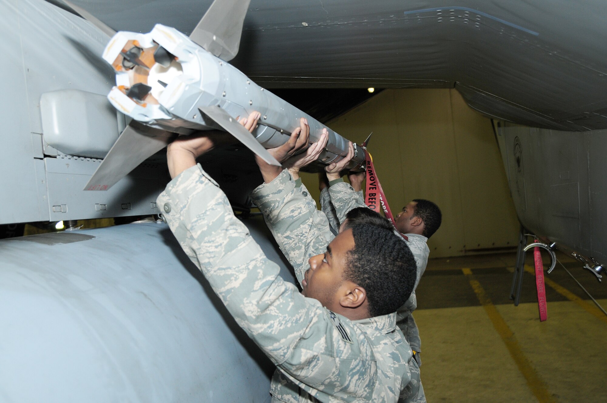 Senior Airman Jonathan Ard (left to right), Staff Sgt. Ronald Townsend and Airman 1st Class Billy Reams load an AIM-9X missile on an F-15C Eagle Sept. 23, 2010, at Keflavik, Iceland. The Airmen are deployed from the 748th Aircraft Maintenance Squadron at Royal Air Force Lakenheath, England, in support of NATO's Icelandic Air Policing Mission. (U.S. Air Force photo/Senior Airman Stephen Linch)