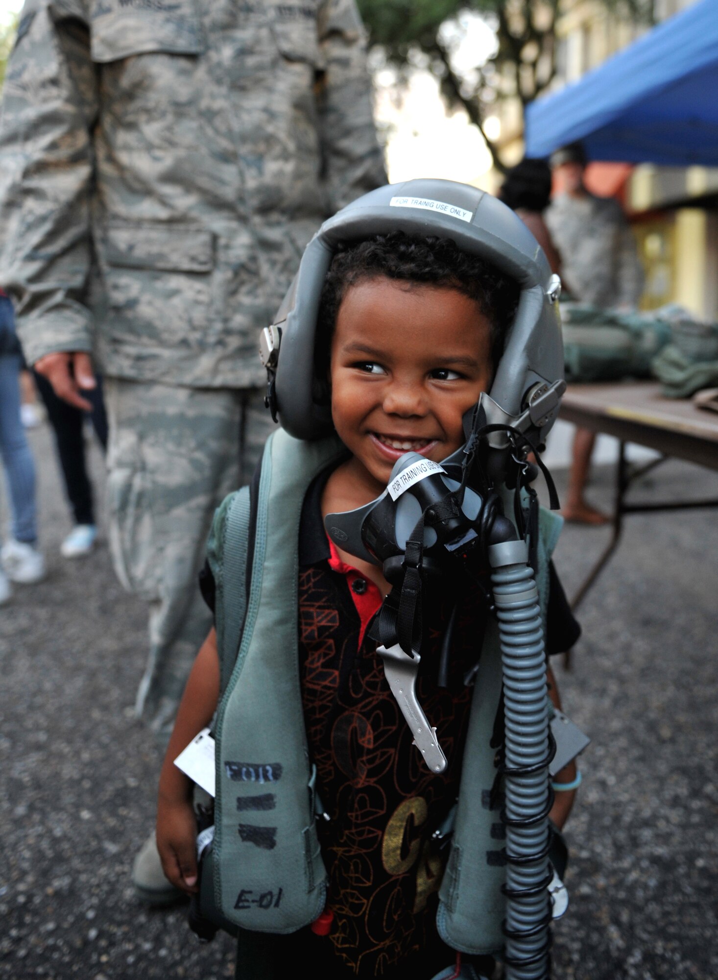 100924-F-4406D-062 SHAW AIR FORCE BASE, S.C.- T.J. Richardson, son of 2nd Lt. Anthony Richardson 20th Fighter Wing Public Affairs Chief, poses while wearing a Joint Helmeted Mounted Cueing System Helmet, and a Harness in downtown Sumter, S.C., Sept. 24, 2010. The Street Fest was a salute to all members stationed at Shaw AFB, Progress Energy, Federal Trade Commission and the City of Sumter.  (U.S. Air Force photo/Airman 1st Class Tabatha L. Duarte (Released)