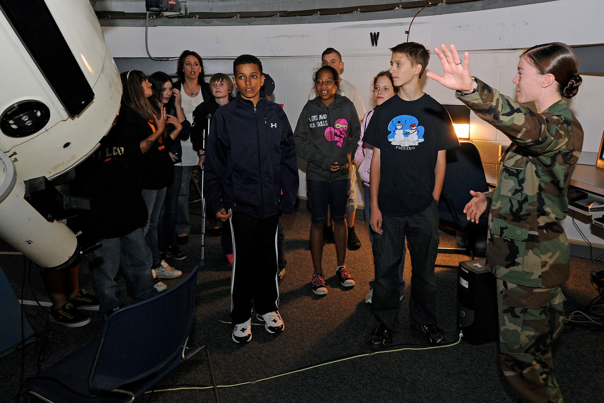 Cadet 1st Class Samantha Howard describes the Air Force Academy's 61-cm reflecting telescopes to students from Falcon Middle School Sept. 24, 2010. About 50 students toured the Academy's observatory and learned about stars and constellations in the early autumn sky as well as far-away objects and the age of the solar system. (U.S. Air Force photo/Mike Kaplan)