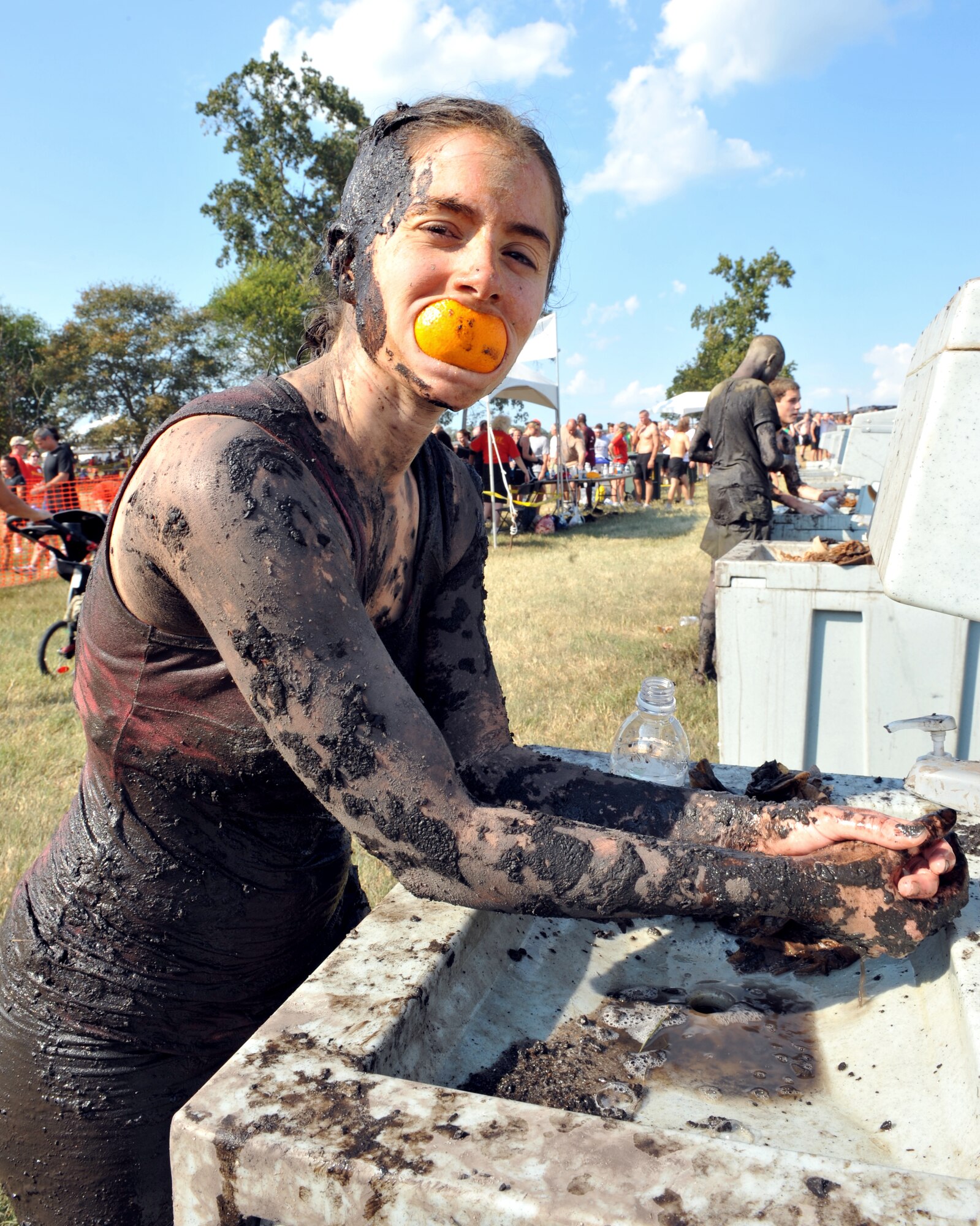 100925-F-4406D-138 SHAW AIR FORCE BASE, S.C.- After finishing the race a contestant washes her hands and poses at the 17th Annual United States Marine Corps Mud Run in Gaston, S.C., Sept. 25, 2010. The USMC Mud Run is held annually to raise money for marines and their families who have been killed on duty. Its profits also go towards scholarships and local events which promote the Marine Corps in the community. (U.S. Air Force photo/Airman 1st Class Tabatha L. Duarte (Released)