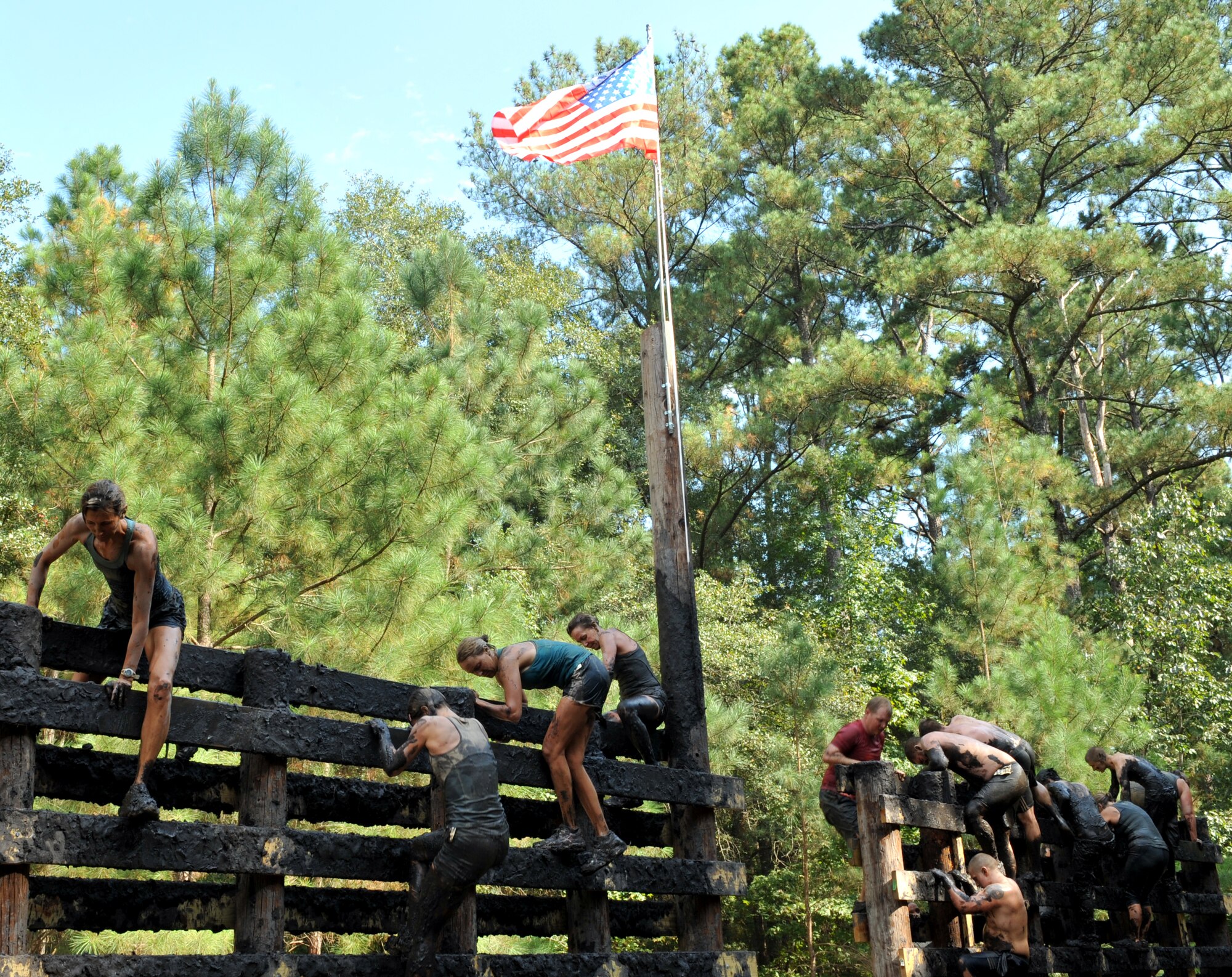 100925-F-4406D-118 SHAW AIR FORCE BASE, S.C.- Contestants complete the "Wall Climb," an obstacle that challenges the contestants to climb up a fifteen foot wall and once at the top, they climb down, at the 17th Annual United States Marine Corps Mud Run in Gaston, S.C., Sept. 25, 2010. The USMC Mud Run is held annually to raise money for Marines and their families who have been killed on duty. Its profits also go towards scholarships and local events which promote the Marine Corps in the community. (U.S. Air Force photo/Airman 1st Class Tabatha L. Duarte (Released)