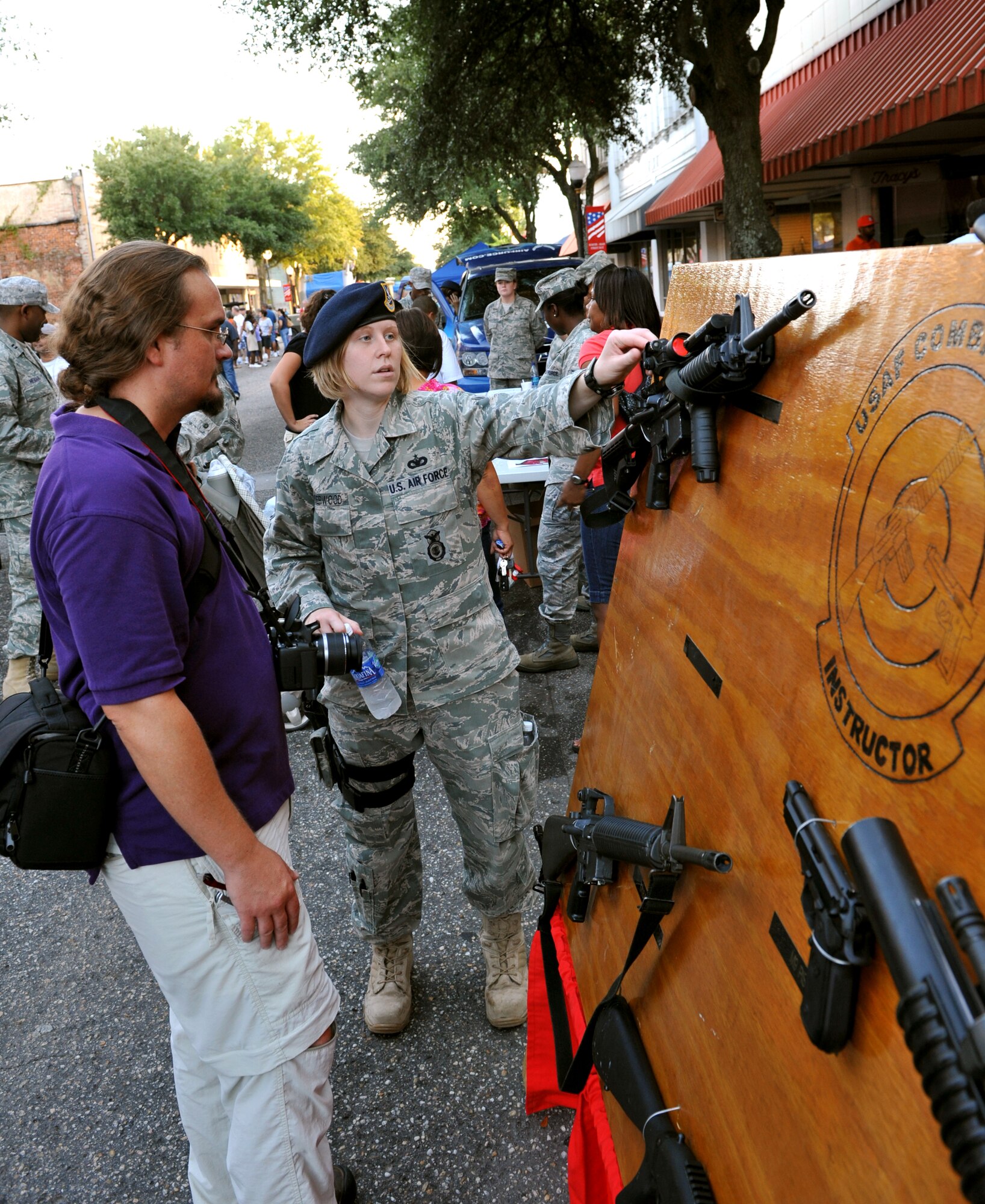 100924-F-4406D-040 SHAW AIR FORCE BASE, S.C.- Staff Sgt. Holly Underwood, 20th Security Forces Squadron patrolman tells a Sumter local about the parts and uses of the M4 rifle downtown Sumter, S.C., Sept. 24, 2010. The Street Fest was a salute to all members stationed at Shaw AFB, Progress Energy, Federal Trade Commission and the City of Sumter.  (U.S. Air Force photo/Airman 1st Class Tabatha L. Duarte (Released)