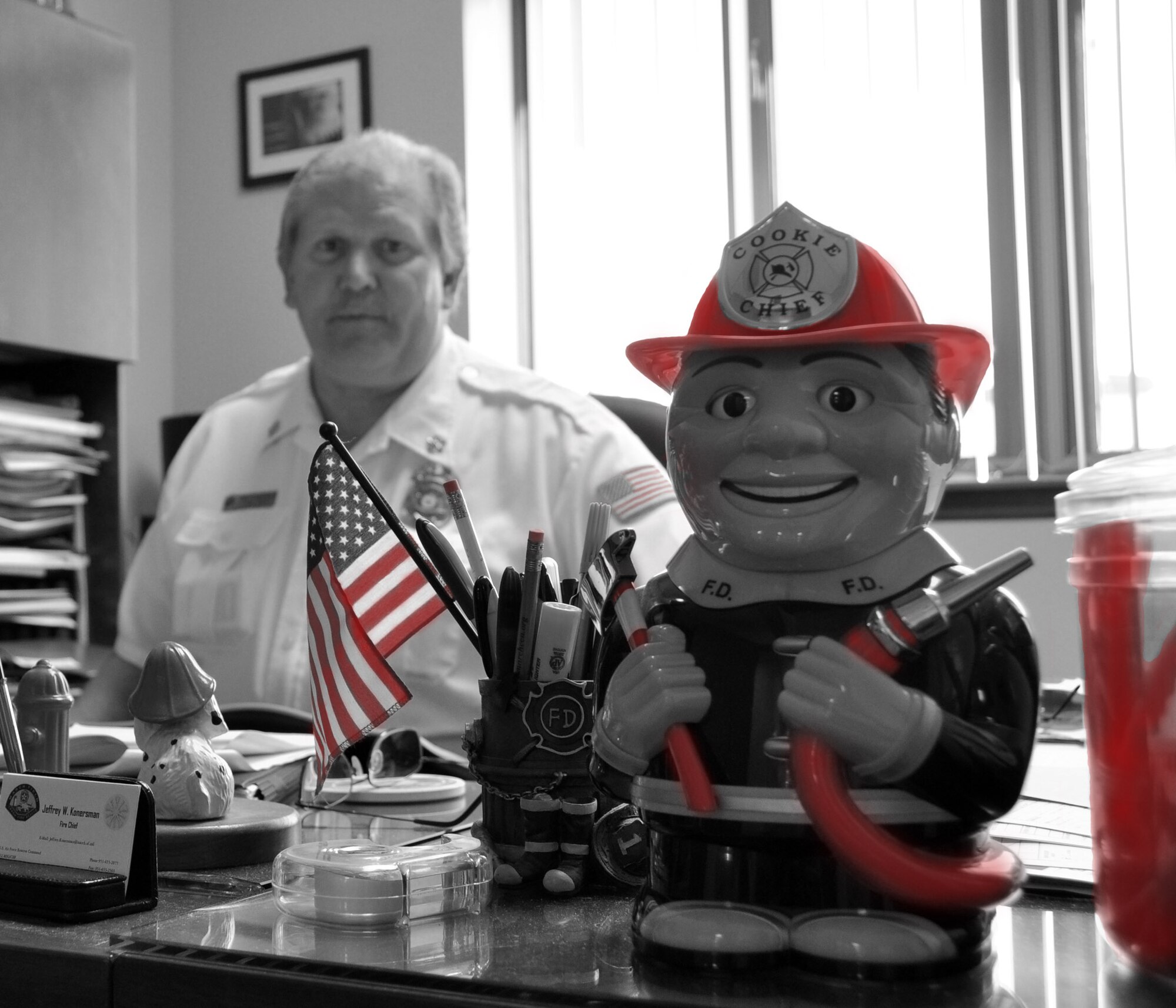 Jeffrey W. Konersman, Chief of Fire Emergency Services, sits at his desk at the March Air Reserve Base Fire Department Sept. 27, 2010.