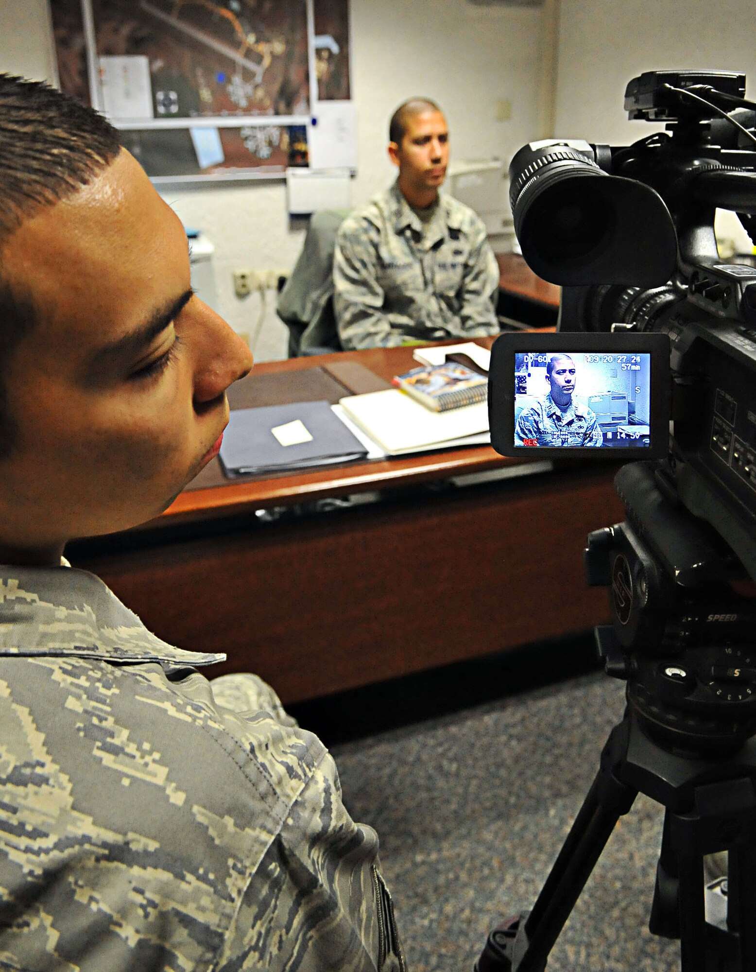 U.S. Air Force Senior Airman Esteban Esquivel, 86th Public Affairs, journalist, inspects his footage of Capt. Christopher Martagon, 86th Logistic Readiness Squadron, flight commander, during an Operation Readiness Inspection, Ramstein Air Base, Germany, Sept. 29, 2010. The ORI is designed to test Airmen's ability to survive, operate and perform fundamental duties in a war time environment. (U.S. Air Force photo by Airman 1st Class Desiree Esposito/Released)