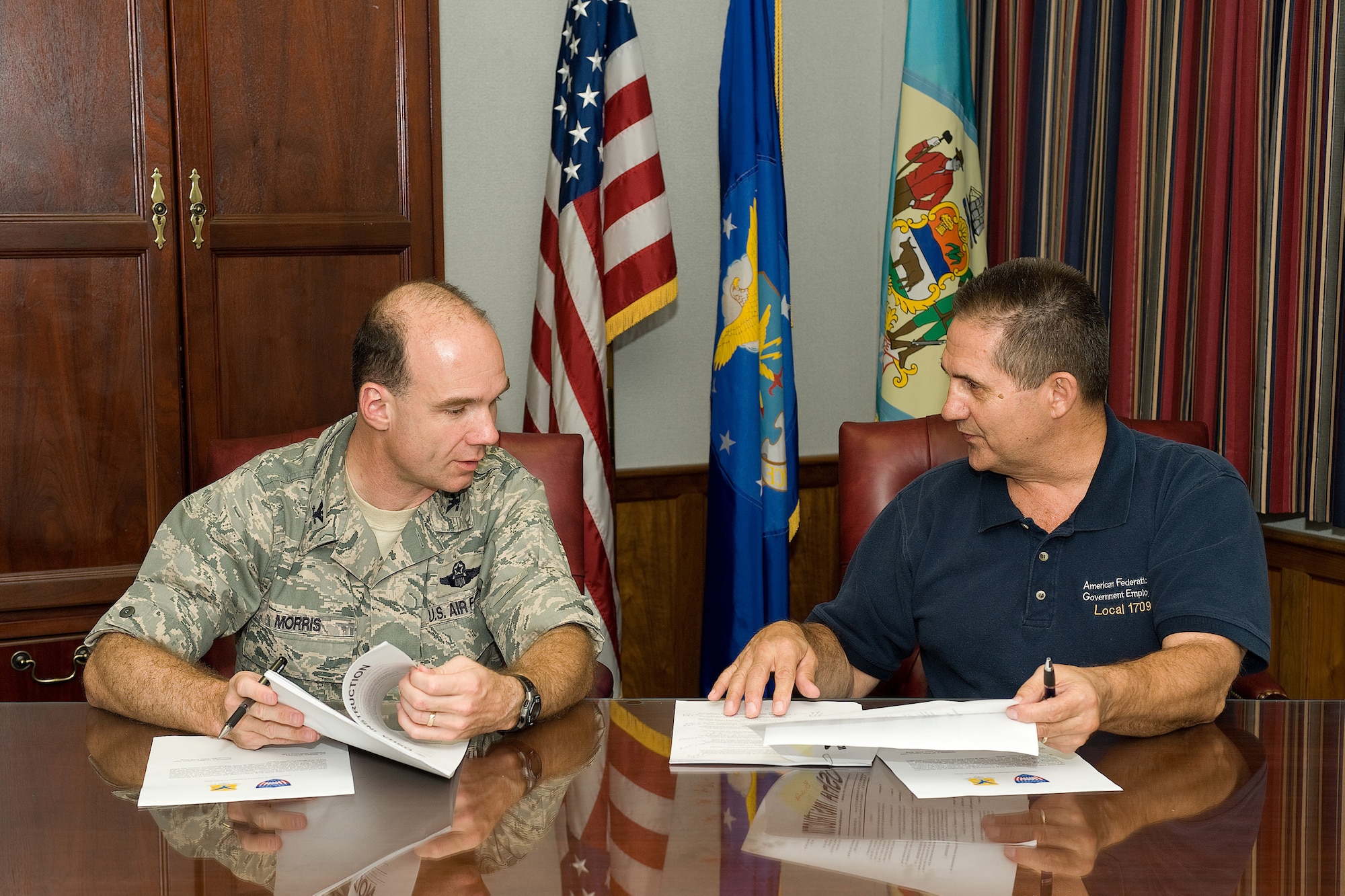Col. Manson Morris, 436th Airlift Wing commander, and Brent Reynolds, American Federation of Government Employees Local 1709 president, discuss ways to help implement the Occupational Safety and Health Administration's Voluntary Protection Program at Dover Air Force Base, Del., Sept. 23, 2010. The program focuses on establishing a proactive and aggressive mishap prevention culture for both leadership and employees. (U.S. Air Force photo by Jason Minto/Released)