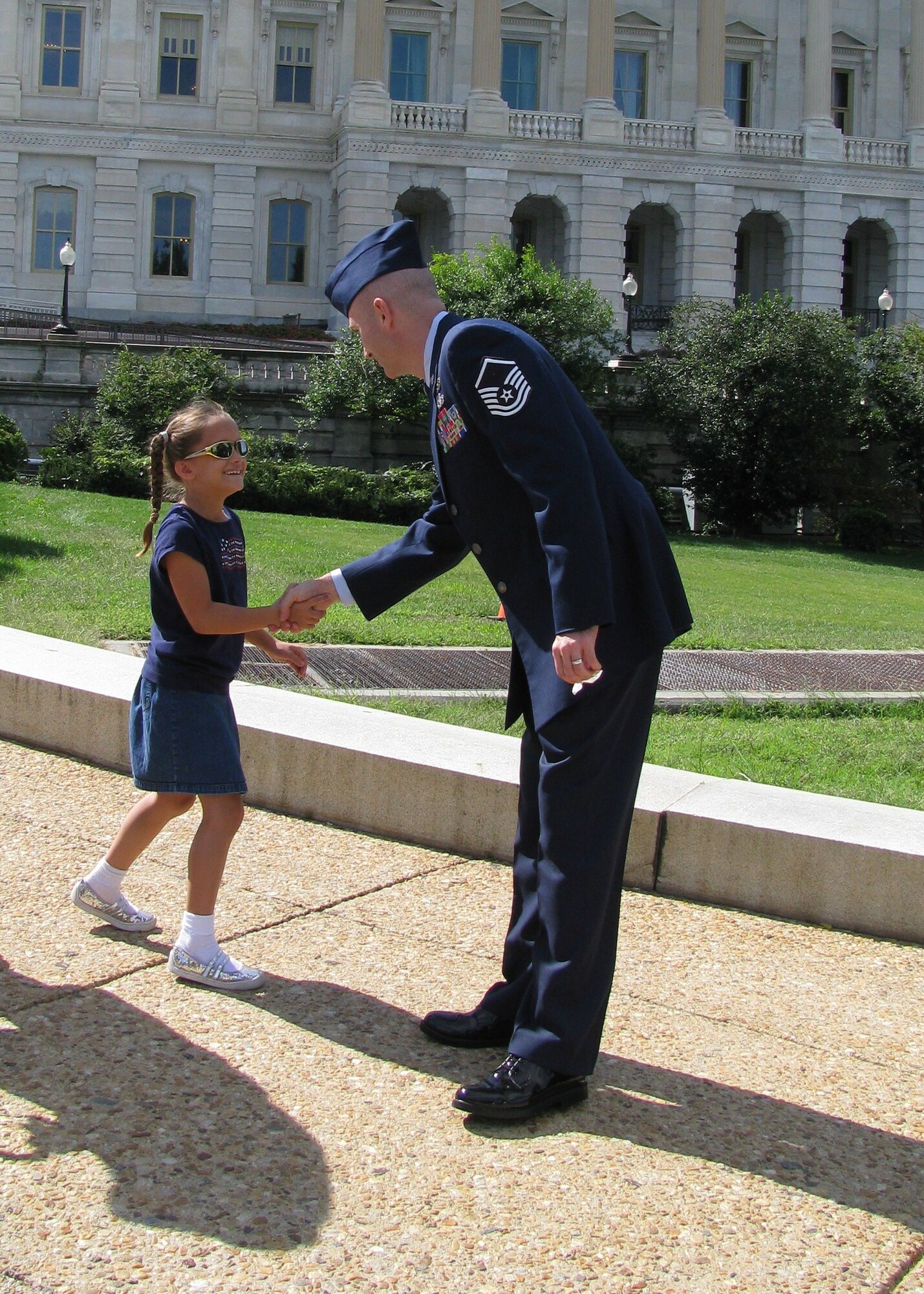 Master Sgt. Stephen Hunter, 944th Civil Engineer Squadron Explosive Ordnance Disposal technican, shakes hands with a girl during a trip to Washington D.C. where he received accolades as one of the 12 Outstanding Airmen of the Year 2010. Sergeant Hunter attended a week of events highlighted by a formal dinner honoring the 12 OAY recipients at the Air Force Association's Air and Space Conference and Technology Exposition. (Courtesy photo)