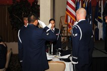 MINOT AIR FORCE BASE, N.D. -- Minot AFB Honor Guard members pay tribute to their fallen brothers and sisters in arms as they setup the POW/MIA table at the Air Force Ball held in the Jimmy Doolittle Center here Sept. 25. Air Force Global Strike Command Airmen from Minot joined for a morale boosting event held annually. (U.S. Air Force photo by Airman 1st Class Aaron-Forrest Wainwright)