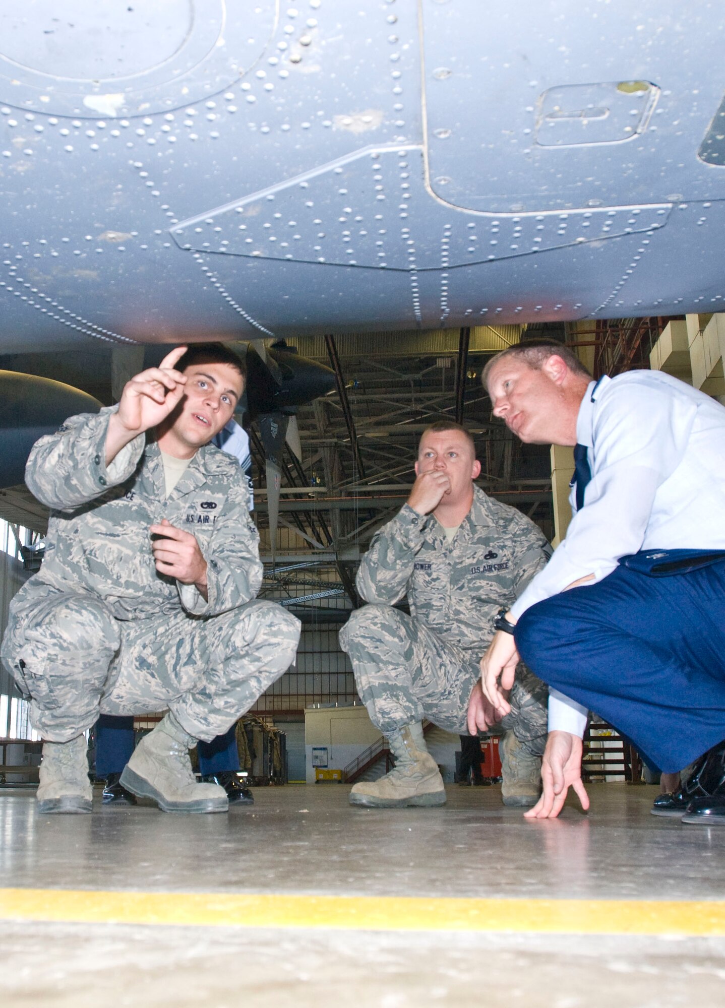 Airman 1st Class Robert Ice (left), 19th Equipment Maintenance Squadron aircraft structural maintenance apprentice, points out examples of aircraft underbelly damage to Col. Michael Zick (right), 19th Airlift Wing vice commander, during a shop visit Monday. The East Liverpool, Ohio, native removed and replaced more than 1,000 fasteners and installed eight patches, salvaging rock-damaged belly skin on three deployed aircraft. (U.S. Air Force photo by Staff Sgt. Nestor Cruz)