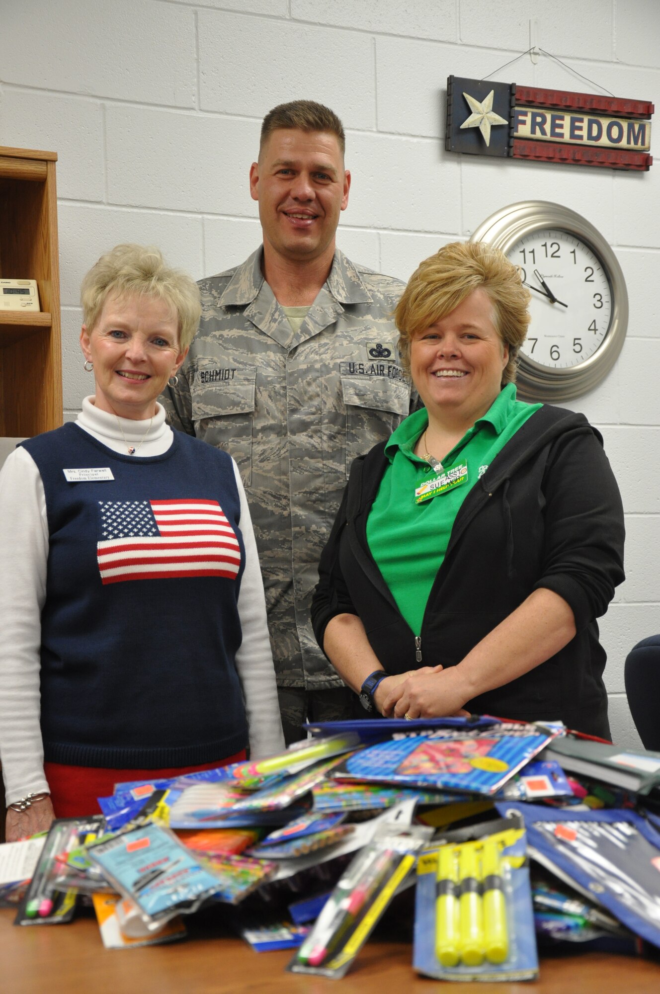 Master Sgt. Lee Schmidt, 90th Missile Maintenance Squadron’s first sergeant, and president of the First Sergeants Council, poses with Cindy Farwell, principal of Freedom Elementary School, and Sue Kelly, from the Cheyenne Dollar Tree, by a portion of the school supply donation received Sept. 24. The Dollar Tree, along with local businesses donated more than $1,000 worth of school supplies to Warren’s Freedom Elementary School to help in the coming school year. (U.S. Air Force photo by A1C Dan Gage)