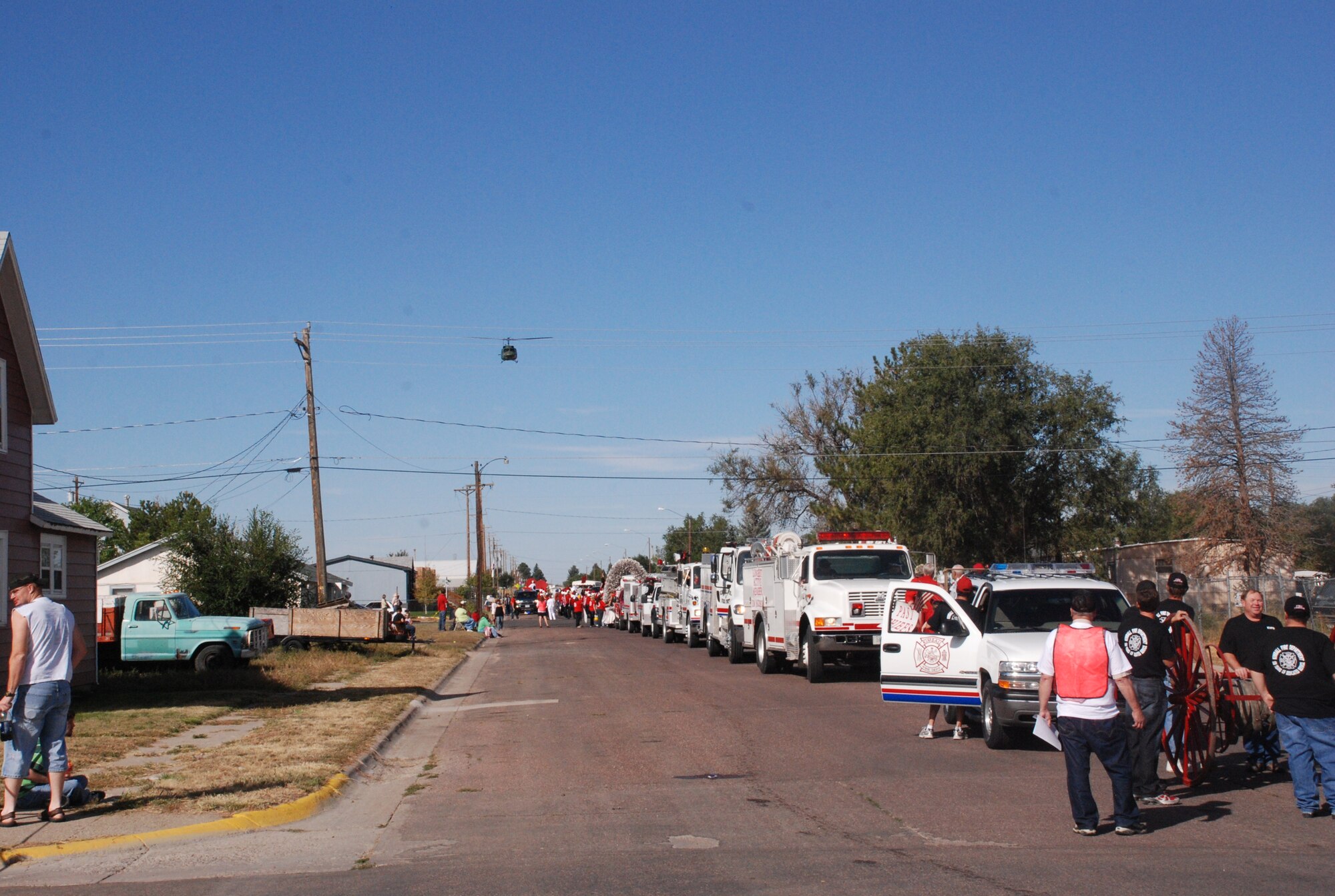 A helicopter provided by F. E. Warren’s 37th Helicopter Squadron flies over the parade route and gathered crowd in Kimball, Neb., to start the Kimball Farmer’s Day Parade on Sept. 25. (U.S. Air Force photo by Staff Sgt. Mike Tryon)