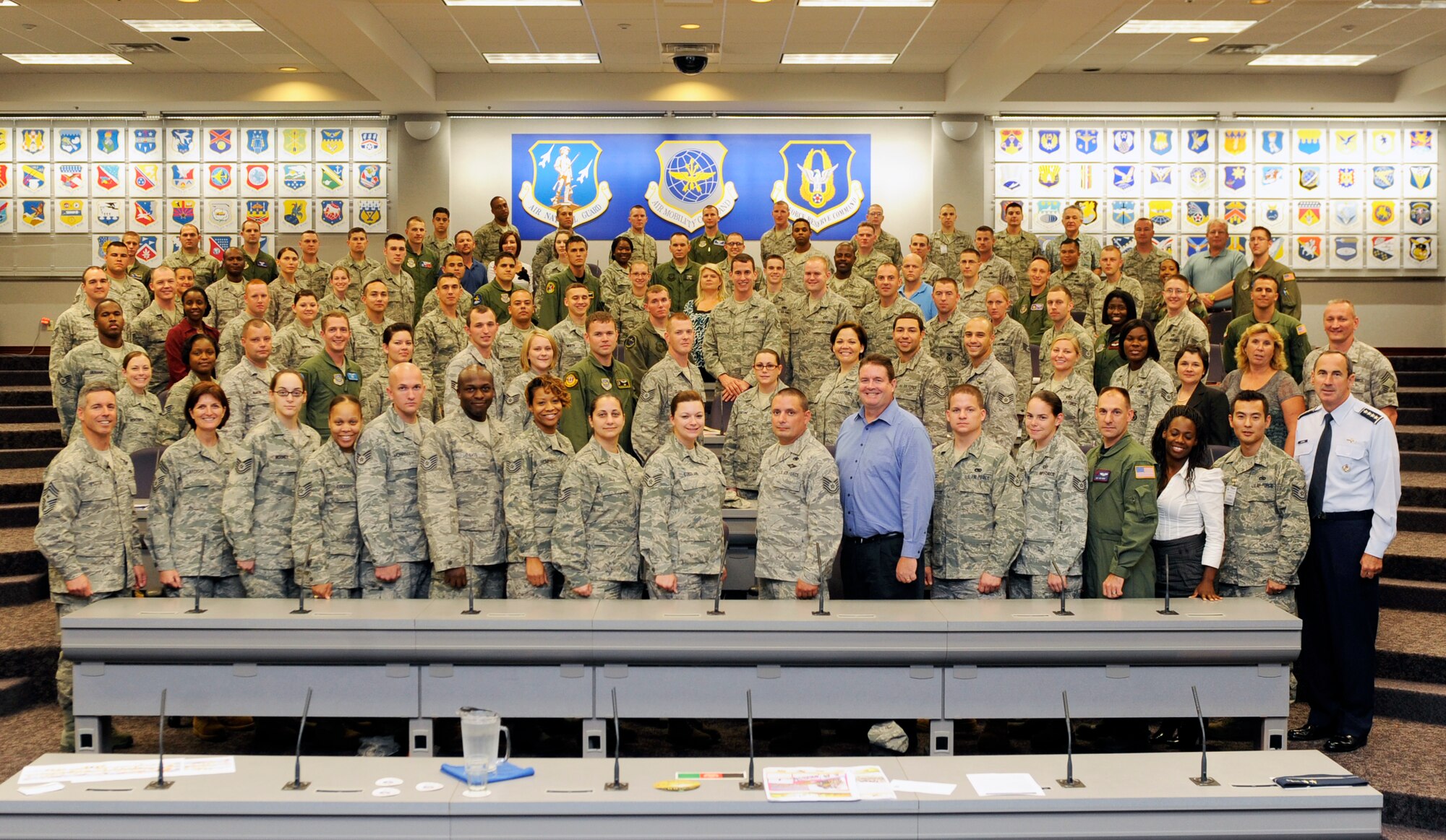 Attendees to Air Mobility Command's Phoenix Stripe leadership conference are pictured Sept. 17, 2010, with (front row, left) Chief Master Sgt. David E. Spector, AMC Command Chief Master Sergeant, and (front row, right) Gen. Raymond E. Johns Jr., AMC Commander, at the Global Reach Planning Center at Scott Air Force Base, Ill.  Phoenix Stripe is a “highly-selective, four-star sponsored” professional development conference for mid-grade enlisted and civilian leaders held at least once each year at Headquarters Air Mobility Command. It provides attendees with an operational overview of all facets of AMC’s Global Reach mission, a broad analysis of key issues impacting air mobility and critical insight into each attendee’s contribution to the Total Force air mobility team. (U.S. Air Force Photo/Staff Sgt. Ryan Crane)