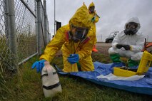 MINOT AIR FORCE BASE, N.D. – Tech. Sgt. Krista Moreau, 5th Medical Operations Squadron bioenvironmental response team member, swabs a simulated hazardous container to determine the contents inside during an exercise here Sept. 23. Exercises like these are vital training tools used throughout the year to ensure wing personnel are trained to provide safe, secure, effective conventional and nuclear operations as mandated by Air Force Global Strike Command. (U.S. Air Force photo by Master Sgt. Michael Gaddis)