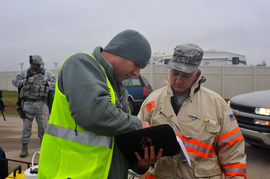 MINOT AIR FORCE BASE, N.D. – Exercise Evaluation Team member, Tech. Sgt. Jay Moreau (left), 5th Civil Engineer Squadron readiness and emergency management superintendent, discusses the incident action plan with Tech. Sgt. Paul Lambert (right), 5th CES hazardous materials assistant fire chief, during an exercise here Sept. 23. Exercises like these are vital training tools used throughout the year to ensure wing personnel are trained to provide safe, secure, effective conventional and nuclear operations as mandated by Air Force Global Strike Command. (U.S. Air Force photo by Master Sgt. Michael Gaddis)