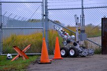 MINOT AIR FORCE BASE, N.D. -- A Northrup-Grunman Remotec  Andros F-6A  robot remotely operated by Airman 1st Class Benjamin Dickson, 5th Civil Engineer Squadron explosive ordnance disposal apprentice, makes its initial approach to a simulated improvised explosive device during an exercise here Sept. 23. The Andros F-6A is used by 5th CES explosive ordnance personnel to recon areas not cleared for human entry. It disarms potential explosive devices while keeping humans safely out of harm’s way. Exercises like these are vital training tools used throughout the year to ensure wing personnel are trained to provide safe, secure, effective conventional and nuclear operations as mandated by Air Force Global Strike Command. (U.S. Air Force photo by Master Sgt. Michael Gaddis)