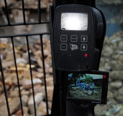 RAF MILDENHALL, England -- Equipment in the cab of a JCB shows the view from behind, so the cab driver can make sure it's safe around the entire area working on the demolition. The quality of the Airmen's quarters had deteriorated and had become surplus to requirements. Once demolition is complete, which is scheduled for January 2011, the area will be landscaped. (U.S. Air Force photo/Karen Abeyasekere)