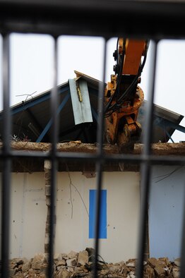 RAF MILDENHALL, England -- A view from the cab of a JCB shows the digger jaws biting into concrete of dormitory 212, ready to rip it apart. The demolition, along with dormitory 213, is due to be completed by January 2011. (U.S. Air Force photo/Karen Abeyasekere)