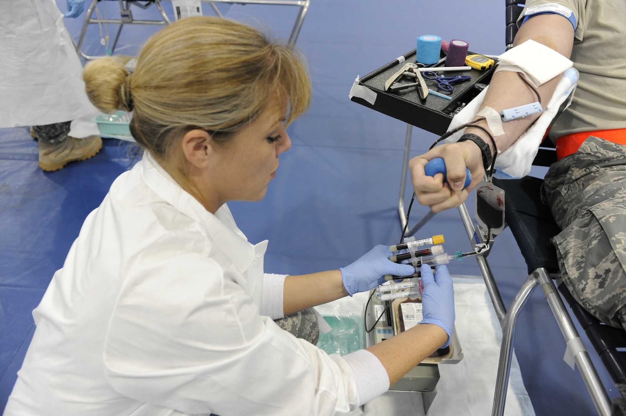 ROYAL AIR FORCE LAKENHEATH, England -- Army Staff Sgt. Sylvia Sacco, United States Army Europe Blood Donor Center mobile team NCO in-charge, fills test tubes with blood during the Armed Services Blood Program held at the fitness center Sept. 27. All donated blood is tested prior to transfusion to minimize risks of reactions or infections disease.  (U.S. Air Force photo/Airman 1st Class Lausanne Morgan)