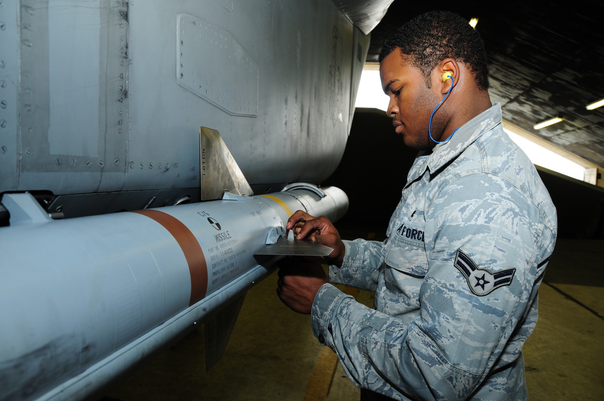 KEFLAVIK, Iceland - Airman 1st Class Billy Reams, 493rd Expeditionary Fighter Squadron Weapons Lload Crew team member, gives the final touches to the munitions load by securing the last fins on an AIM-120 Advanced Medium-Range Air-to-Air Missile on Sept. 23. (U.S. Air Force photo/Senior Airman Stephen Linch)