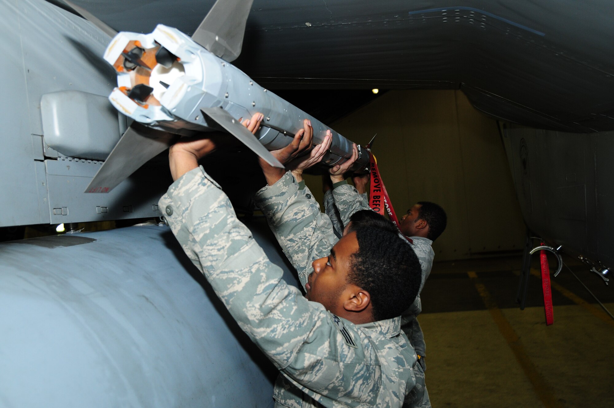 KEFLAVIK, Iceland – Senior Airman Jonathan Ard (left), Staff Sgt. Ronald Townsend and Airman 1st Class Billy Reams (right), 493rd Expeditionary Fighter Squadron Weapons Load Crew team members, load an AIM-9X missile on an F-15C Eagle on Sept. 23. Airmen Ard and Reams and Sergeant Townsend are deployed from the 748th Aircraft Maintenance Squadron at RAF Lakenheath, England, in support of NATO’s Icelandic Air Policing Mission. (U.S. Air Force photo/Senior Airman Stephen Linch)