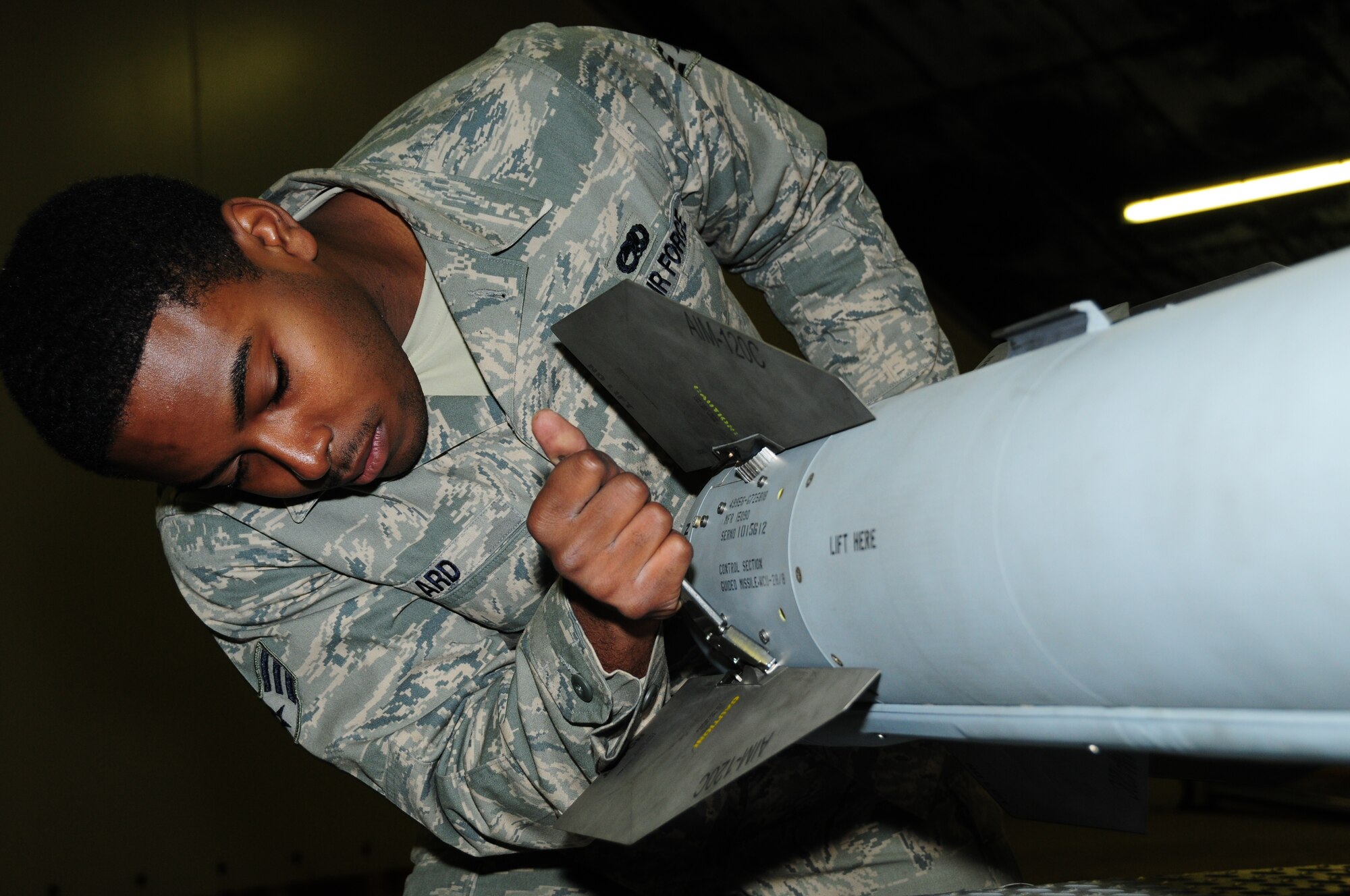 KEFLAVIK, Iceland - Senior Airman Jonathan Ard, 493rd Expeditionary Fighter Squadron Weapons Load Crew team member, tightens a fin on an AIM-120 Advanced Medium-Range Air-to-Air Missile on Sept. 23. (U.S. Air Force photo/Senior Airman Stephen Linch)