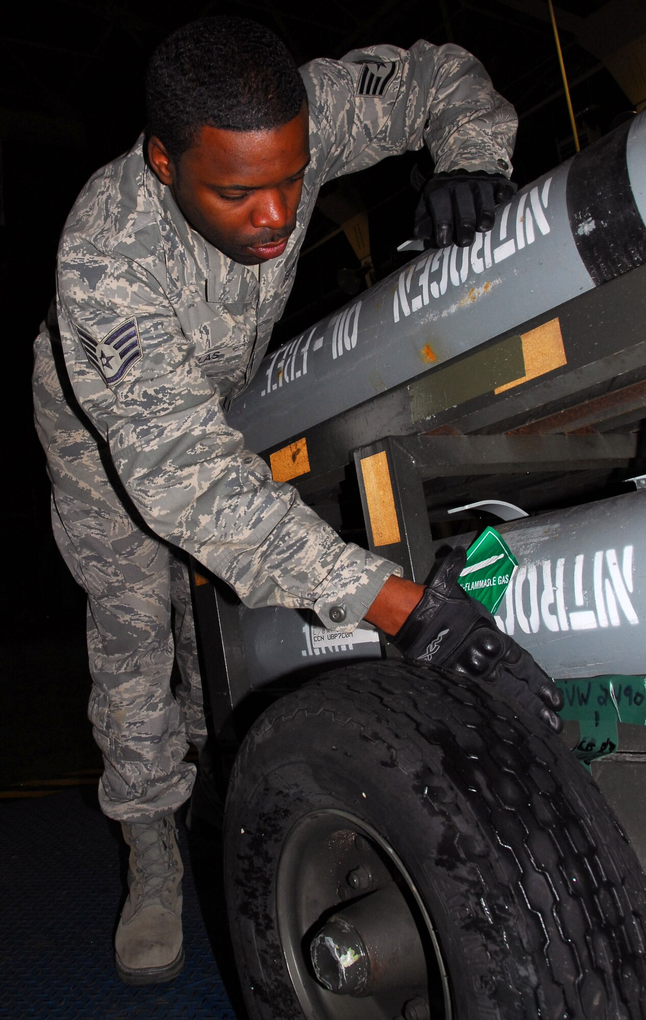 Staff Sgt. Douglas Jattak, 35th Logistics Readiness Squadron, labels the weight of a pallet carrying hydrogen tanks at Misawa Air Base, Japan, Sept. 24, 2010. The cargo was recently sent with 35th Fighter Wing deployers in support of Operation New Dawn . As part of LRS’ cargo deployment function, the pallet was inspected, marshaled into a loading pattern and loaded onto an aircraft. (U.S. Air Force photo by 1st Lt. Cammie Quinn/ Released)