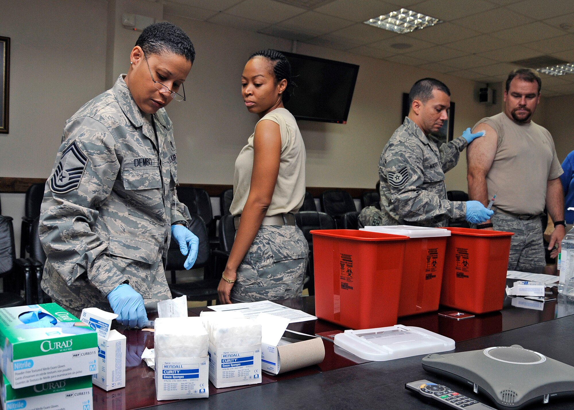 Members of the 332nd Expeditionary Medical Group inoculate wing staff personnel with the influenza vaccine in the wing conference room Sept. 28, 2010, Joint Base Balad, Iraq. To fight the flu, the Air Force Theater Hospital is immunizing all military and civillian personnel on base  for the seasonal flu and H1N1 virus. (U.S. Air Force photo/ Senior Airman Matt Coleman-Foster)