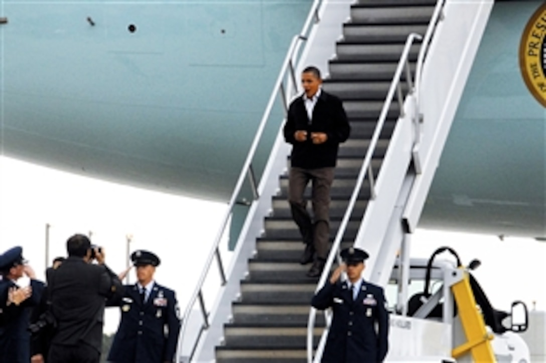 President Barack Obama reacts as U.S. Air Force Brig. Gen. Joseph Brandemuehl, commander of the Wisconsin Air National Guard's 115th Fighter Wing, salutes him as he exits Air Force One at the 115th Fighter Wing base on Truax Field, Wis., Sept. 28, 2010. Obama was en route to an event at the University of Wisconsin. This is the second time a sitting president has visited the 115th Fighter Wing.