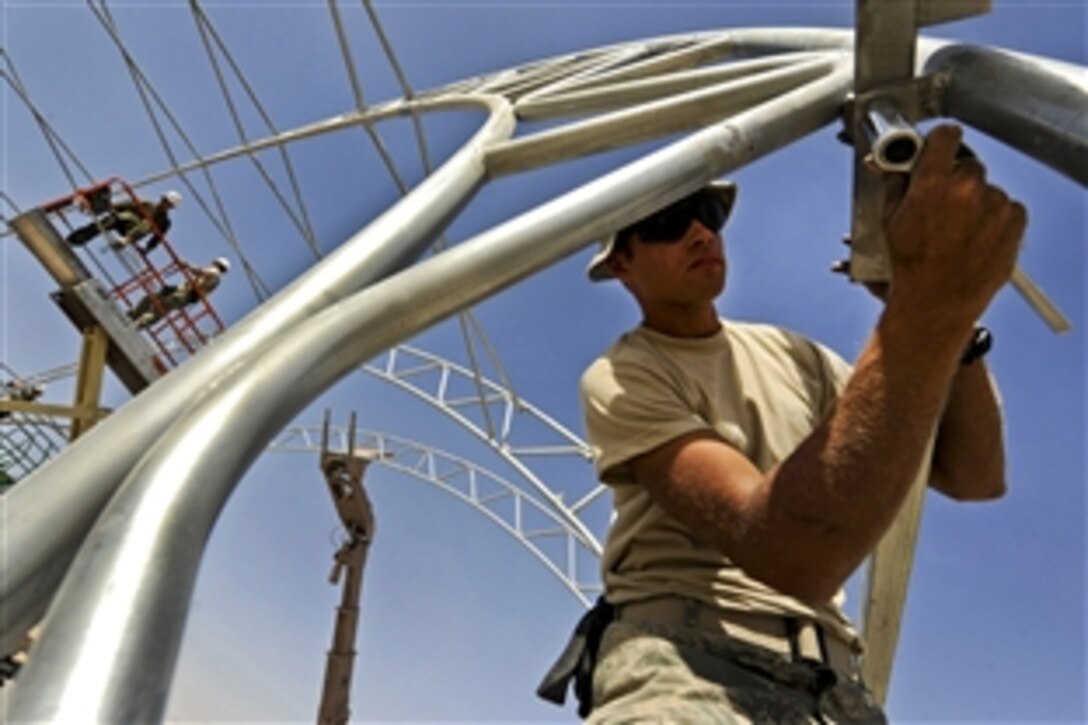 U.S. Air Force Senior Airman Jonathan Carmona secures square tubing to a metal frame on Kandahar Airfield, Afghanistan, Sept. 23, 2010. Airman Carmona is a structural journeyman assigned to the 777th Expeditionary Prime Beef Squadron.