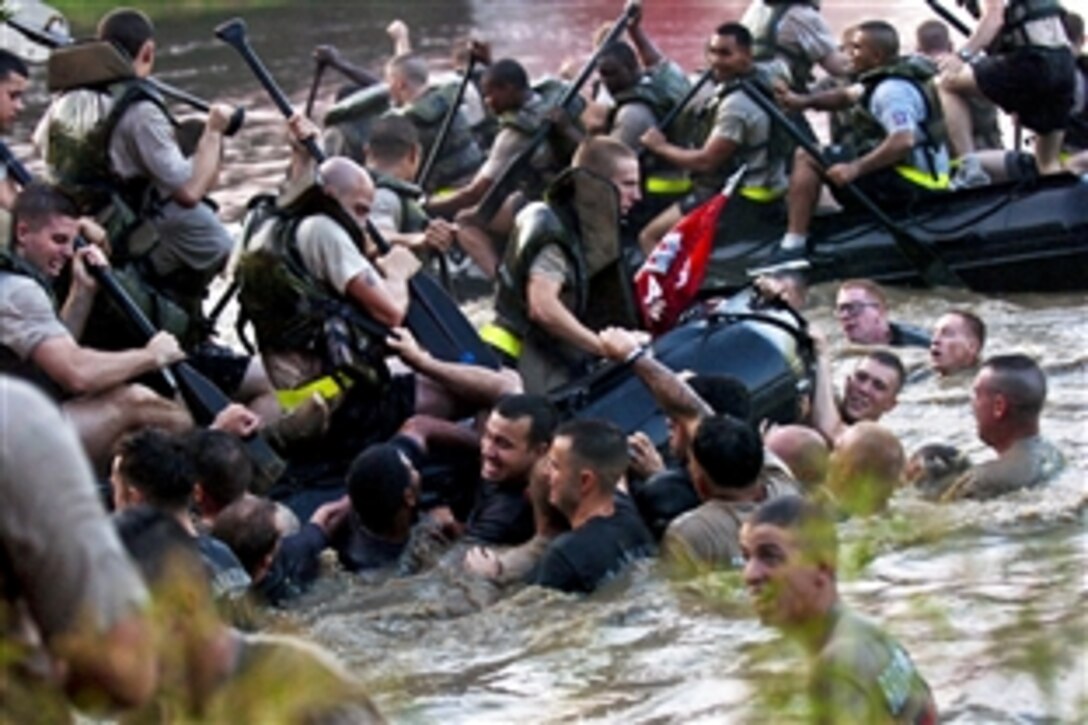 U.S. Army soldiers attempt to "repel boarders" during a fierce Zodiak boat race held by the four engineer companies assigned to the 82nd Airborne Division's brigade combat teams on Fort Bragg, N.C., Sept., 24, 2010. The race in part commemorates the 307th Engineer Battalion's historic crossing of the Waal River during World War II.