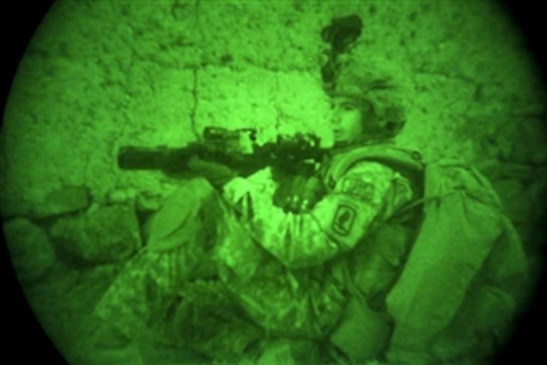 As seen through a night-vision device, a U.S. Army soldier pulls security outside a house in the Chak district, Wardak province, Afghanistan, Sept. 24, 2010. The soldier is assigned to Company A, 1st Battalion, 503rd Infantry Regiment, 173rd Airborne Brigade Combat Team.