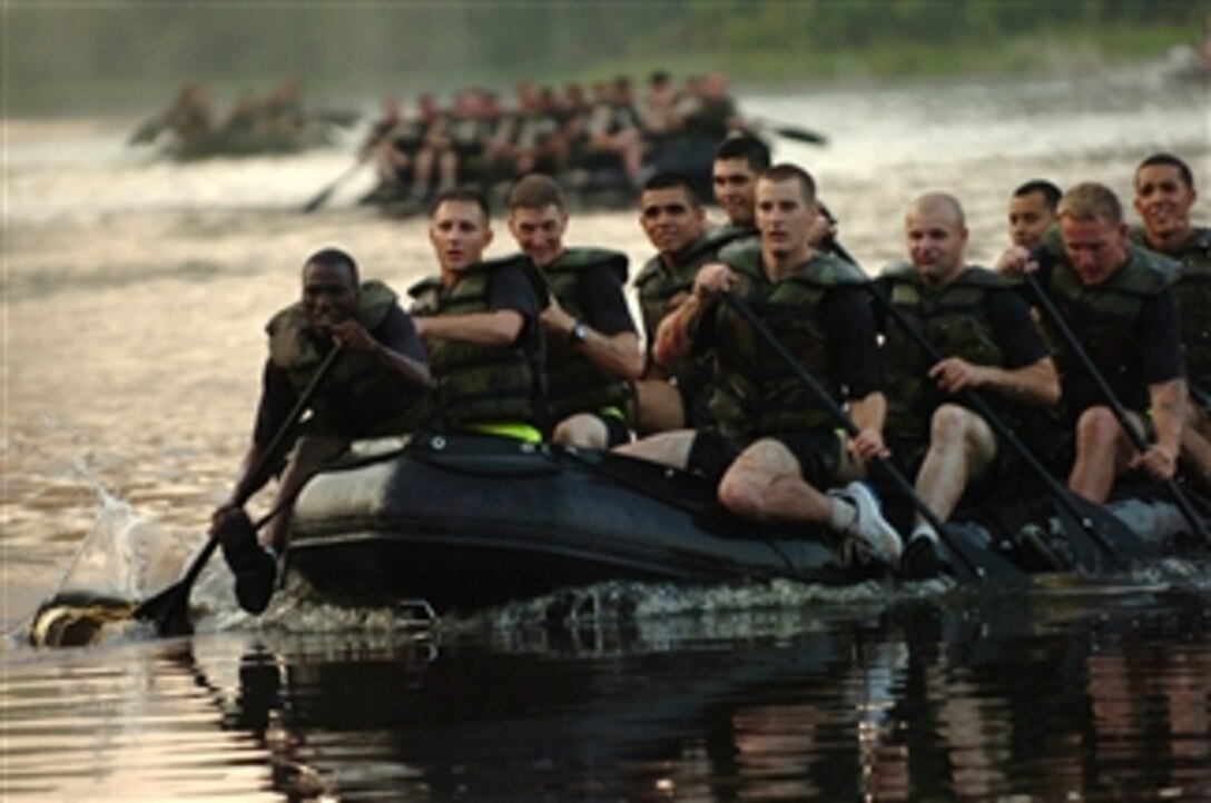 Straining at the oars, Airborne Engineers from 3rd Brigade Combat Team make their way to shore during a Zodiak boat race involving the four engineer companies of the 82nd Airborne Division's Brigade Combat Teams at Fort Bragg, N.C., on Sept. 24, 2010.  The race is part of a commemoration at Fort Bragg on McKeller's lake in honor of the 307th Engineer Battalion's historic crossing of the Waal River during World War II.  