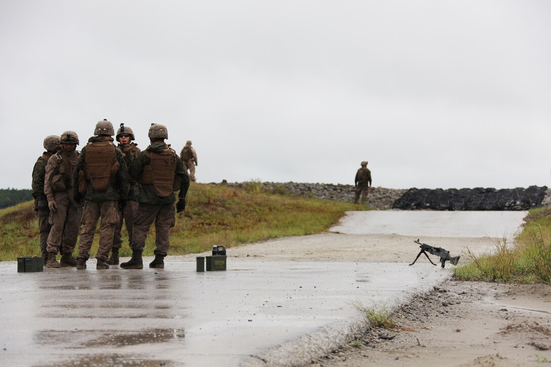 Marine machine gunners with Echo and Fox companies, 2nd Battalion, 2nd Marine Regiment, wait to fire M-240B medium machine guns during a training evolution aboard Camp Lejeune, N.C., Sept. 29, 2010. Companies Echo, Fox and Golf, conducted a ten day training exercise including a MK-19 40mm automatic grenade launcher training course.