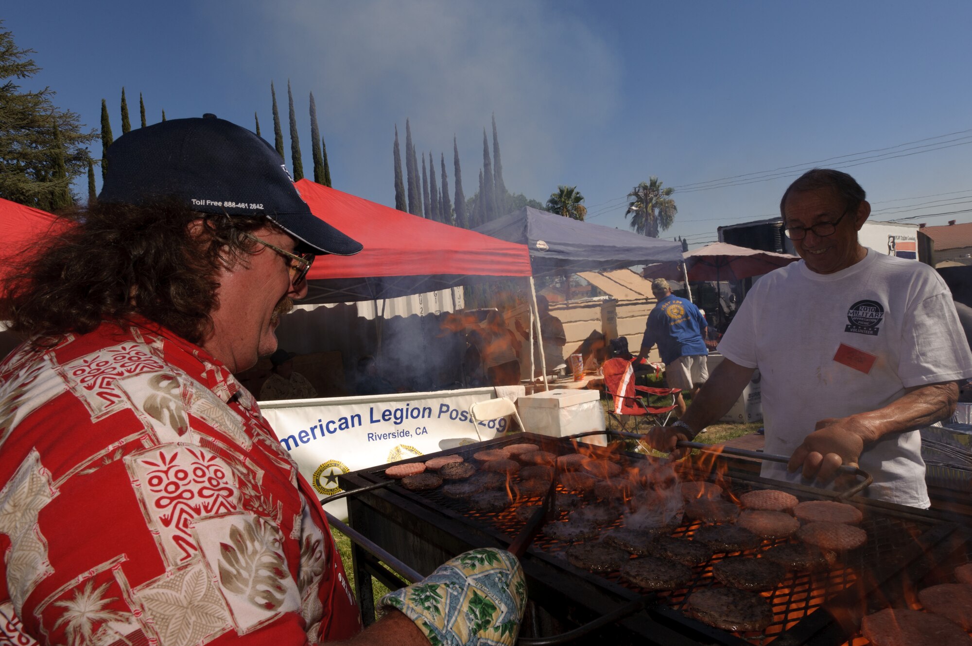 Tim Connacher, from Riverside, and David Albers, from Moreno Valley, grill hamburger patties during the 38th Annual Military Appreciation Picnic at March Air Reserve Base, Calif., Sept. 18. (U.S. Air Force photo by Staff Sgt. Matthew Smith)