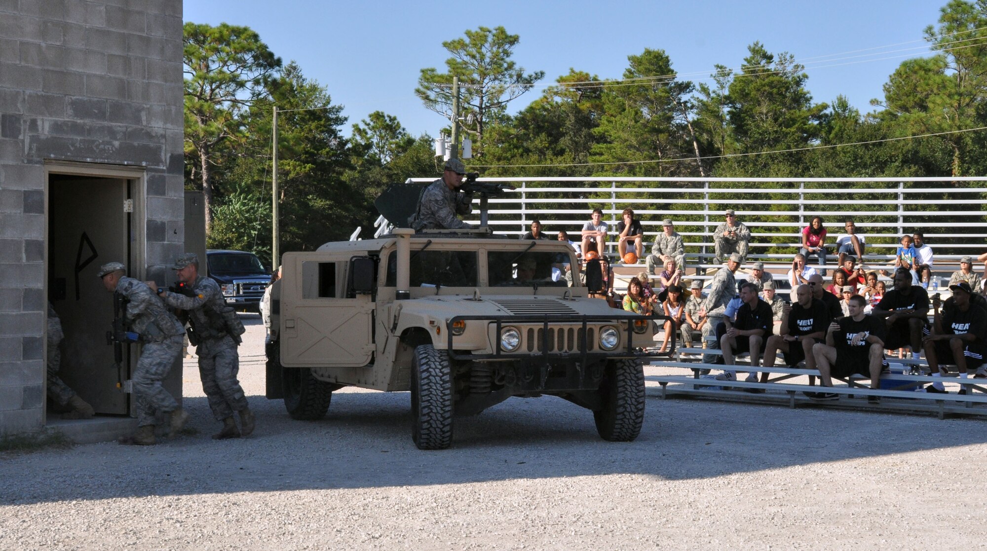 The Miami Heat watch as Airman from the 96th Ground Combat Training Squadron perform an urban warfare scenario Sept. 30 here. (U.S. Air Force photo/Staff Sgt. Stacia Zachary)