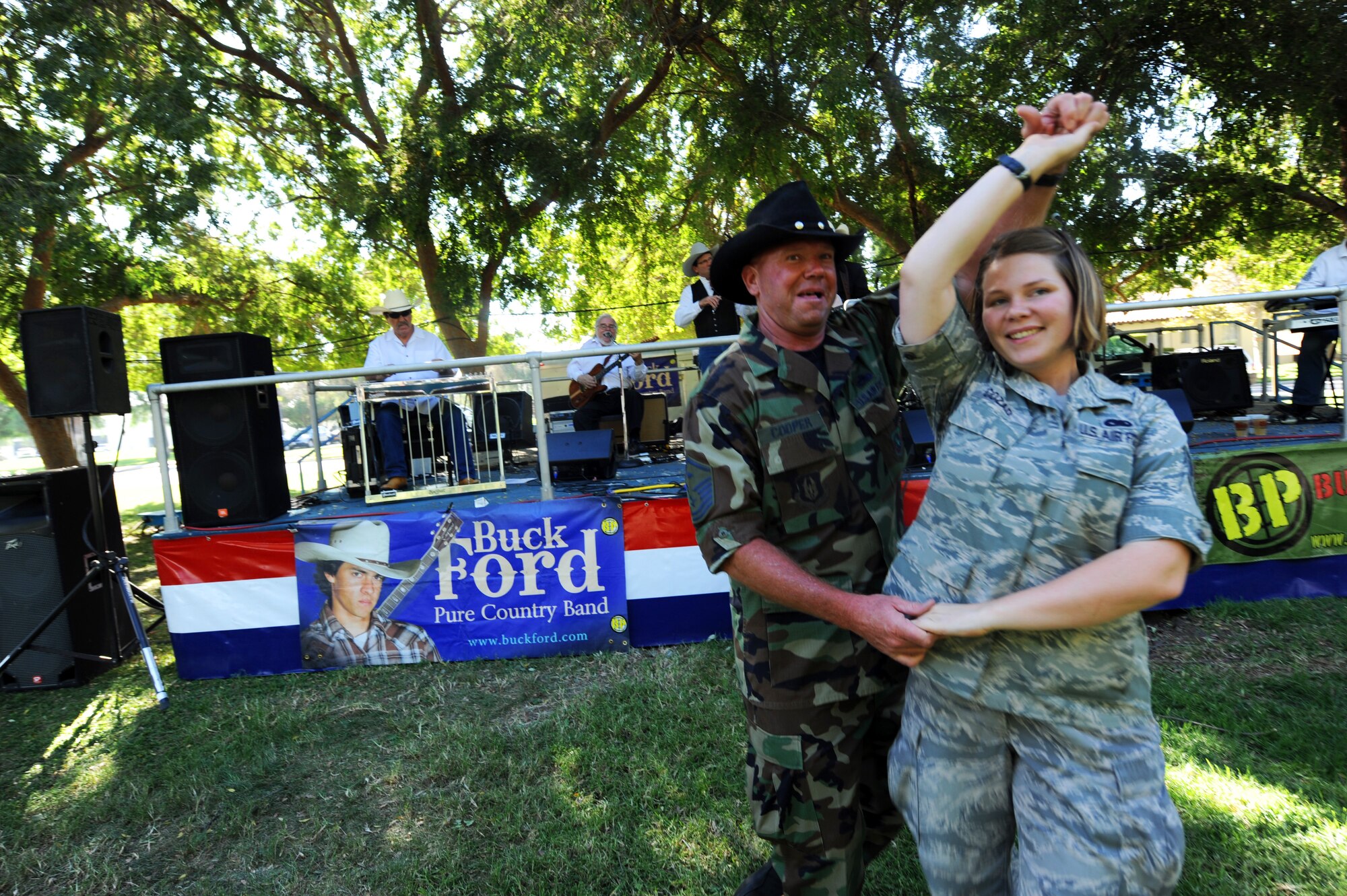 Master Sgt. Randy Cooper, 336th ARS, dances with Staff Sgt. Heather Cozad, 4th CTCS, as country band Buck Ford plays at the 38th Annual Military Appreciation Picnic at March Air Reserve Base, Calif., Sept. 18. (U.S. Air Force photo by Tech. Sgt. Christine Jones)
