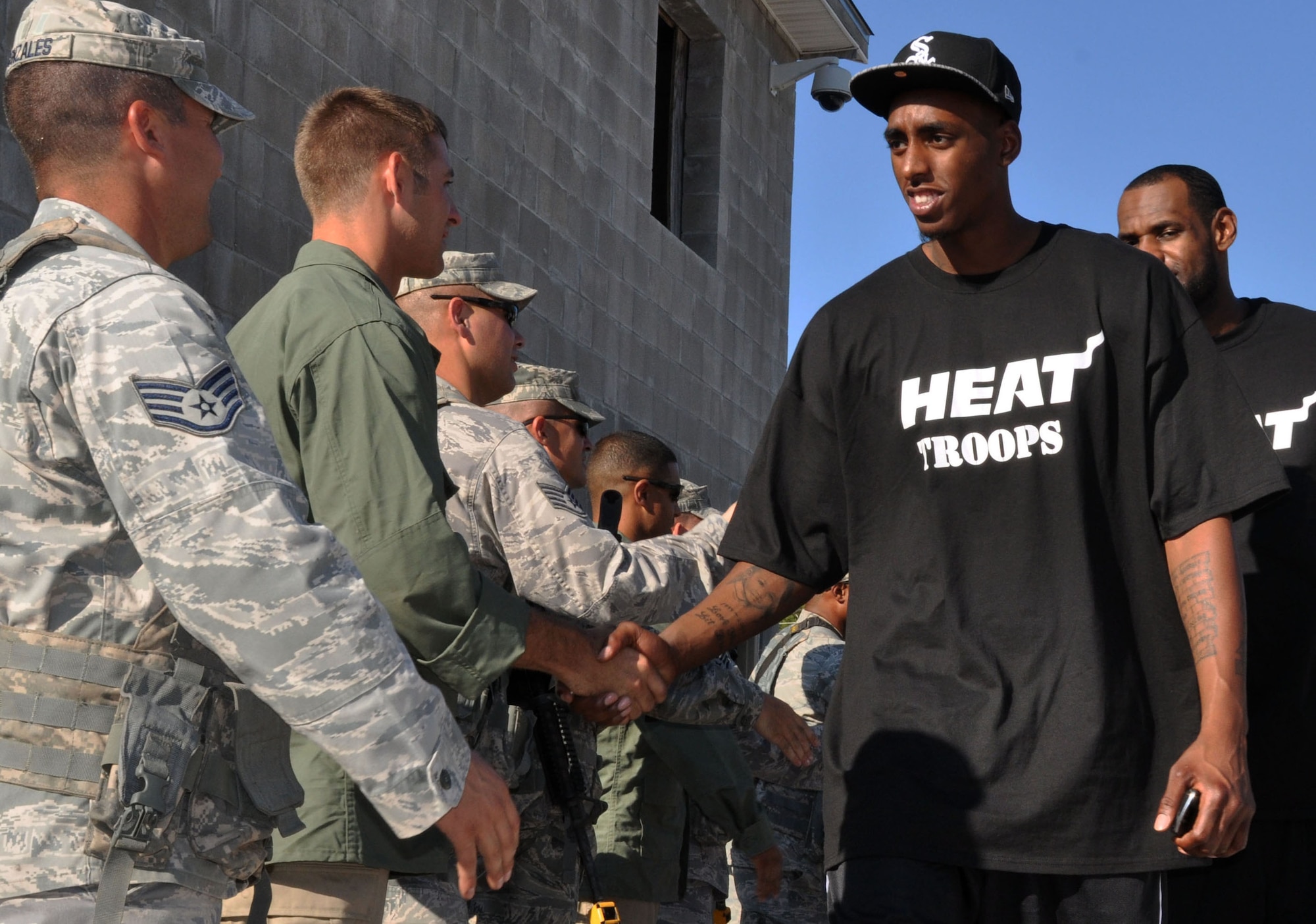 The Miami Heat's Anthony Mason and fellow teammates meet Airman from the 96th Ground Combat Training Squadron following an urban warfare scenario was performed Sept. 30 here. (U.S. Air Force photo/Staff Sgt. Stacia Zachary)