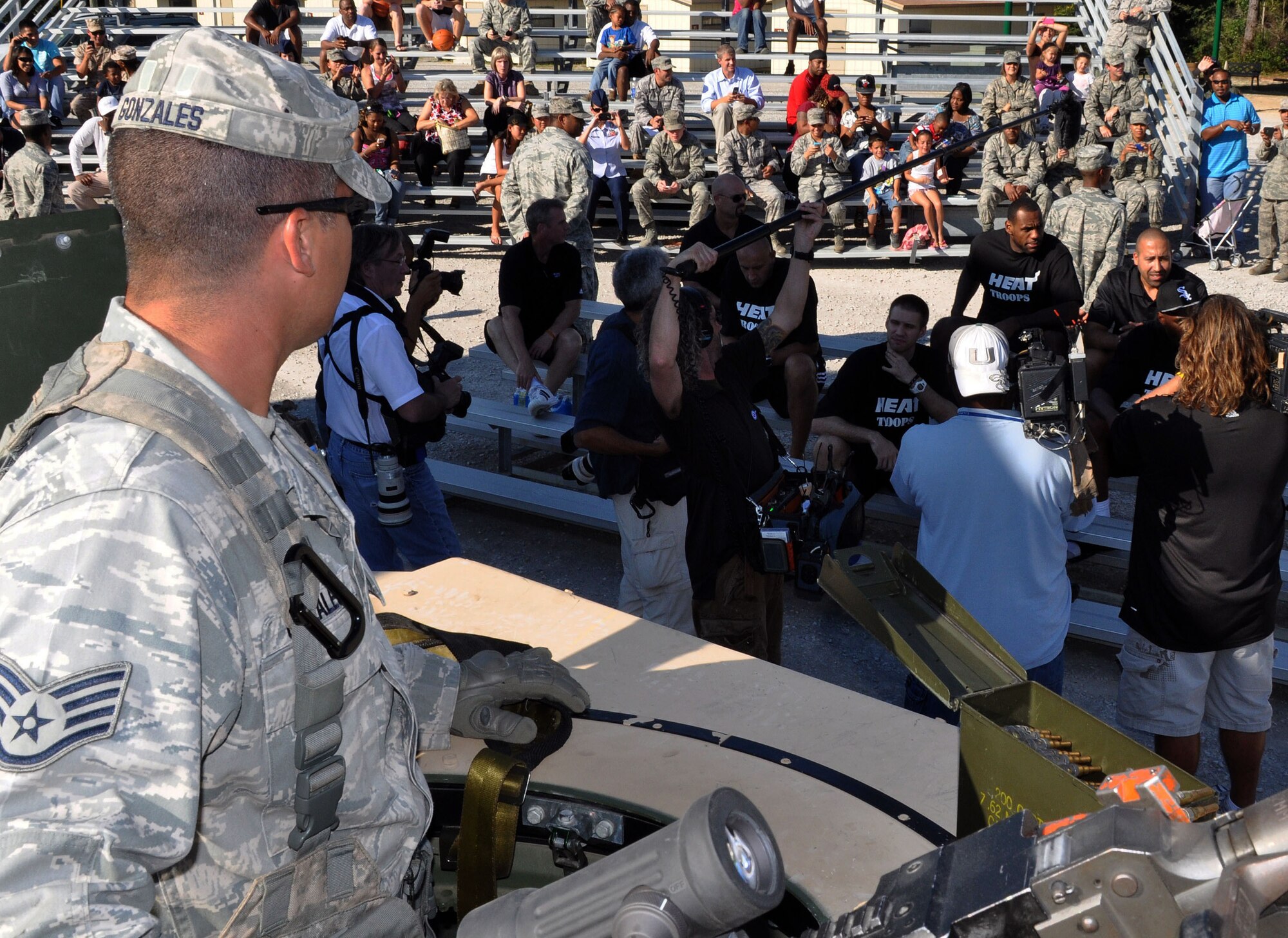 Staff Sgt, Adrian Gonzales, 96th Ground Combat Training Squadron, arms a weapon in a high mobility multi-purpose wheeled vehicle (HMMWV) turret after an urban warfare scenario is performed for members of the Miami Heat. (U.S. Air Force photo/Staff Sgt. Stacia Zachary)