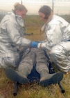 KUNSAN AIR BASE, Republic of Korea -- Senior Airman Shaylee Bell and Airman Amy Gley, 8th Civil Engineer Squadron firefighters, work together to transport a victim of a simulated plane crash during exercise Beverly Hotel 10-6 here Sept. 27, 2010. During the exercise Airmen worked together to get all the victims to safety, extinguish the burning aircraft, and practiced self-aid and buddy care. (U.S. Air Force photo/Senior Airman Ciara Wymbs) 