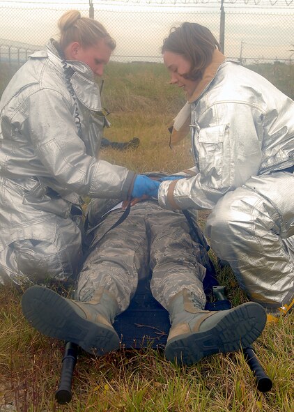 KUNSAN AIR BASE, Republic of Korea -- Senior Airman Shaylee Bell and Airman Amy Gley, 8th Civil Engineer Squadron firefighters, work together to transport a victim of a simulated plane crash during exercise Beverly Hotel 10-6 here Sept. 27, 2010. During the exercise Airmen worked together to get all the victims to safety, extinguish the burning aircraft, and practiced self-aid and buddy care. (U.S. Air Force photo/Senior Airman Ciara Wymbs) 