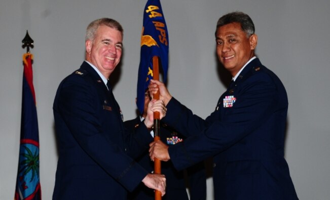 The 44th Aerial Port Squadron welcomes a new commander when Maj. Anthony San Nicolas accepts the unit guidon from Col. Robert “Randy” Huston, 624th Regional Support Group commander, at a ceremony held Sept. 25, 2010, at the base theater, Andersen Air Force Base, Guam. (Air Force Courtesy Photo)