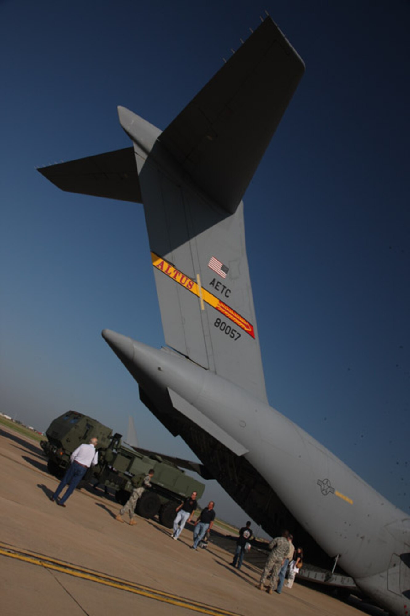 A group of Soldiers, Airmen and civilians board a C-17 Sept. 16 after pilots from the 58th Airlift Squadron, Altus AFB landed the aircraft and taxied on the runway of Lawton-Fort Sill Regional Airport. The group gathered to test an upgrade to the fire control system on High Mobility Artillery Rocket Systems during flight. (U.S. Army photo by Marie Berberea)