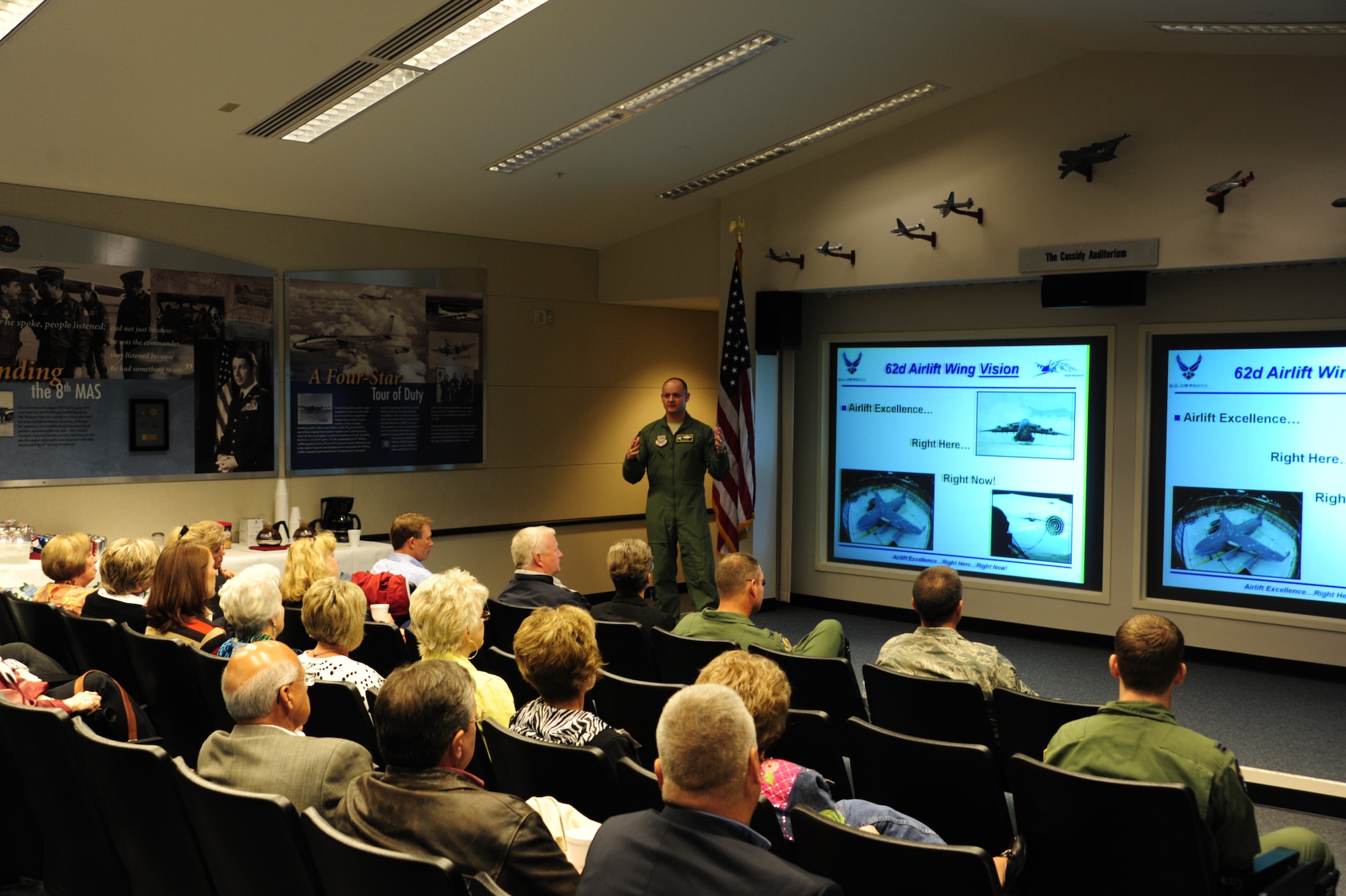Col. Kevin Kilb, 62nd Airlift Wing Commander, gives an introduction and mission brief Sept. 30 at Joint Base Lewis McChord, Wash., to civic leaders from Altus Air Force Base, Okla. Colonel Kilb described the duties and responsibilities of loadmasters dispersed throughout the flying squadrons at McChord Field. Altus AFB is one of the training locations for loadmasters. (U.S. Air Force Photo/Airman Leah Young)