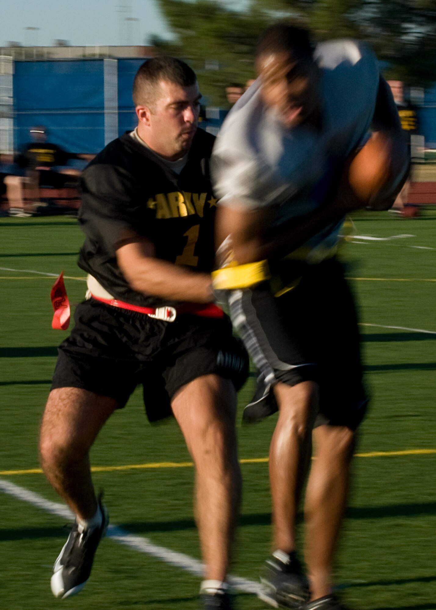 GOODFELLOW AIR FORCE BASE, Texas -- 344th Army defenders, Anthony Marolo attempts to pull the flag of a 17th Mission Support Group Junk Yard Dog player, during intramural play at the base football field Sept. 27. A last second touchdown by Army tied the game at 13-13, forcing overtime. With four downs each, the Junk Yard Dogs were able to outplay Army by 23-yards, helping to secure a 1-point lead. The Dogs advanced to play Army again for the championship. (U.S. Air Force photo/ Senior Airman Tong Duong)