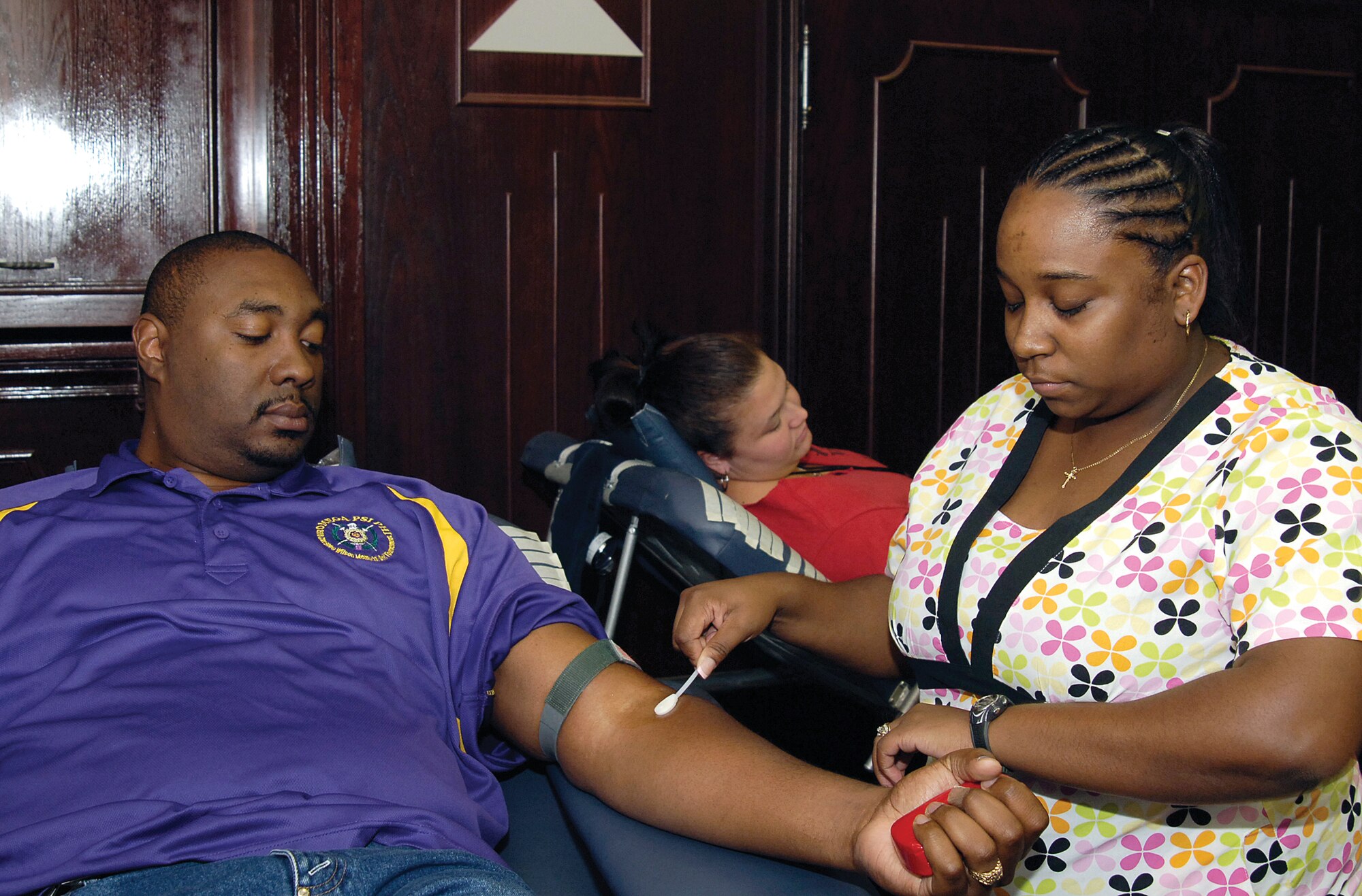 Regular blood donors Devin Hodge and Amanda Sauviller are attended to by Oklahoma Blood Institute phlebotomist Crystal Buckner during a Sept. 24 blood drive in Bldg. 3001.  Mr. Hodge is with the Oklahoma City Air Logistics Center’s Engineer Directorate and Ms. Sauviller is a PALACE Acquire intern in the F108 area.  (Air Force photo by Margo Wright)