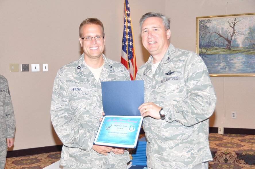 Capt. Troy Fiesel receives his superior performer award from Col. Darrell G. Young, 934th Airlift Wing commander, at the post inspection recognition luncheon Sept. 28. (Air Force Photo/Paul Zadach)