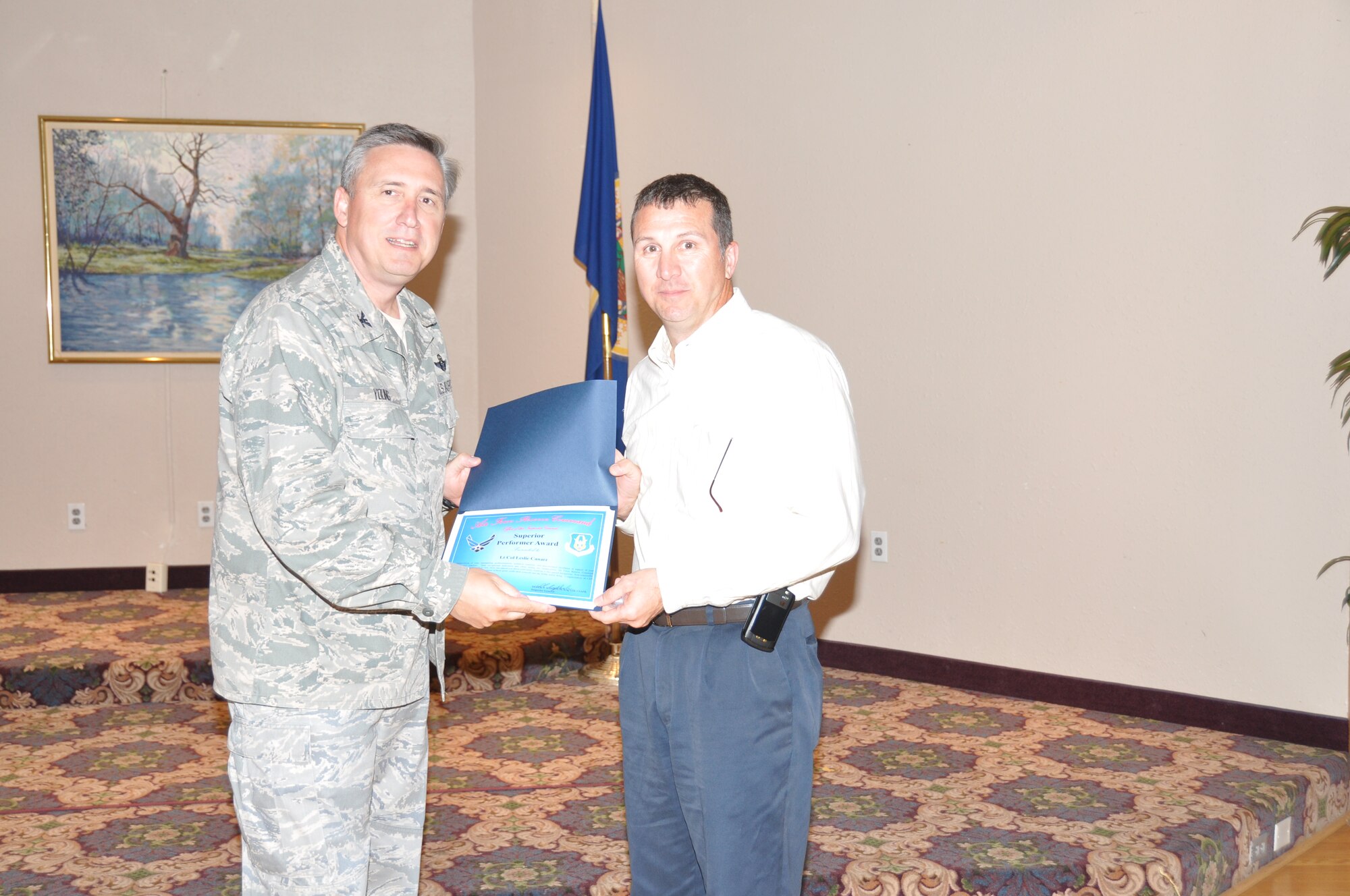 Mr. Les Canaar receives his superior performer award from Col. Darrell G. Young, 934th Airlift Wing commander, at the post inspection recognition luncheon Sept. 28. (Air Force Photo/Paul Zadach)