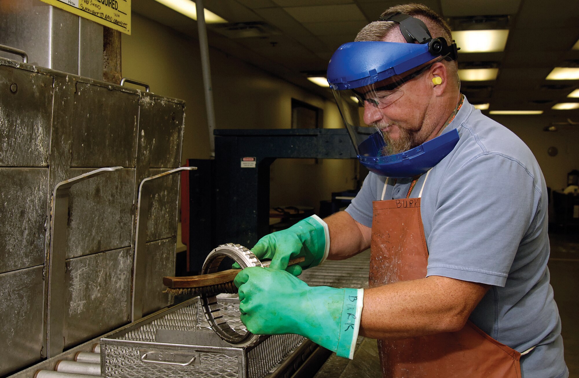 John Burk cleans an F119 #4 bearing inner ring in the cleaning room of the Bearing Shop before sending it through the shop for inspection. (Air Force photo by Margo Wright)