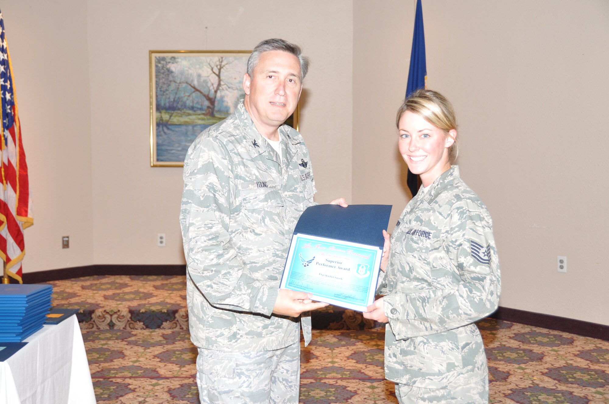 Tech. Sgt. Rachel Snook receives her superior performer award from Col. Darrell G. Young, 934th Airlift Wing commander, at the post inspection recognition luncheon Sept. 28. (Air Force Photo/Paul Zadach)
