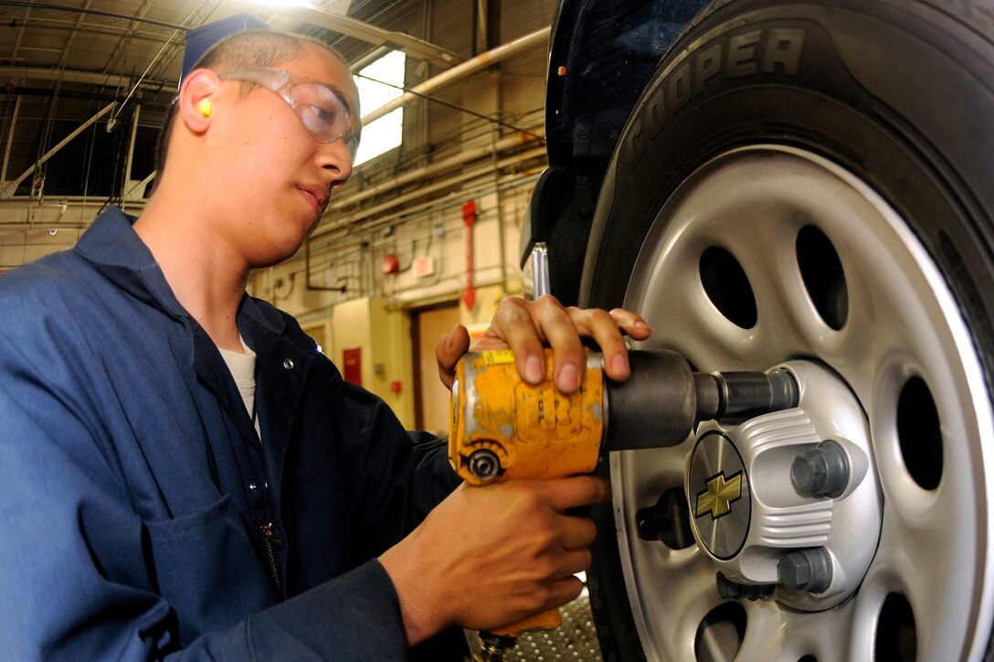 ELLSWORTH AFB, S.D. - Airman Jayson Berdonado, 28th Logistics Readiness Squadron vehicle mechanic, removes lug nuts from a government vehicle while preparing to inspect a brake rotor, Sept. 21.  The brake system forces brake pads onto the rotors to slow a vehicle. (U.S. Air Force photo/Staff Sgt. Marc I. Lane)